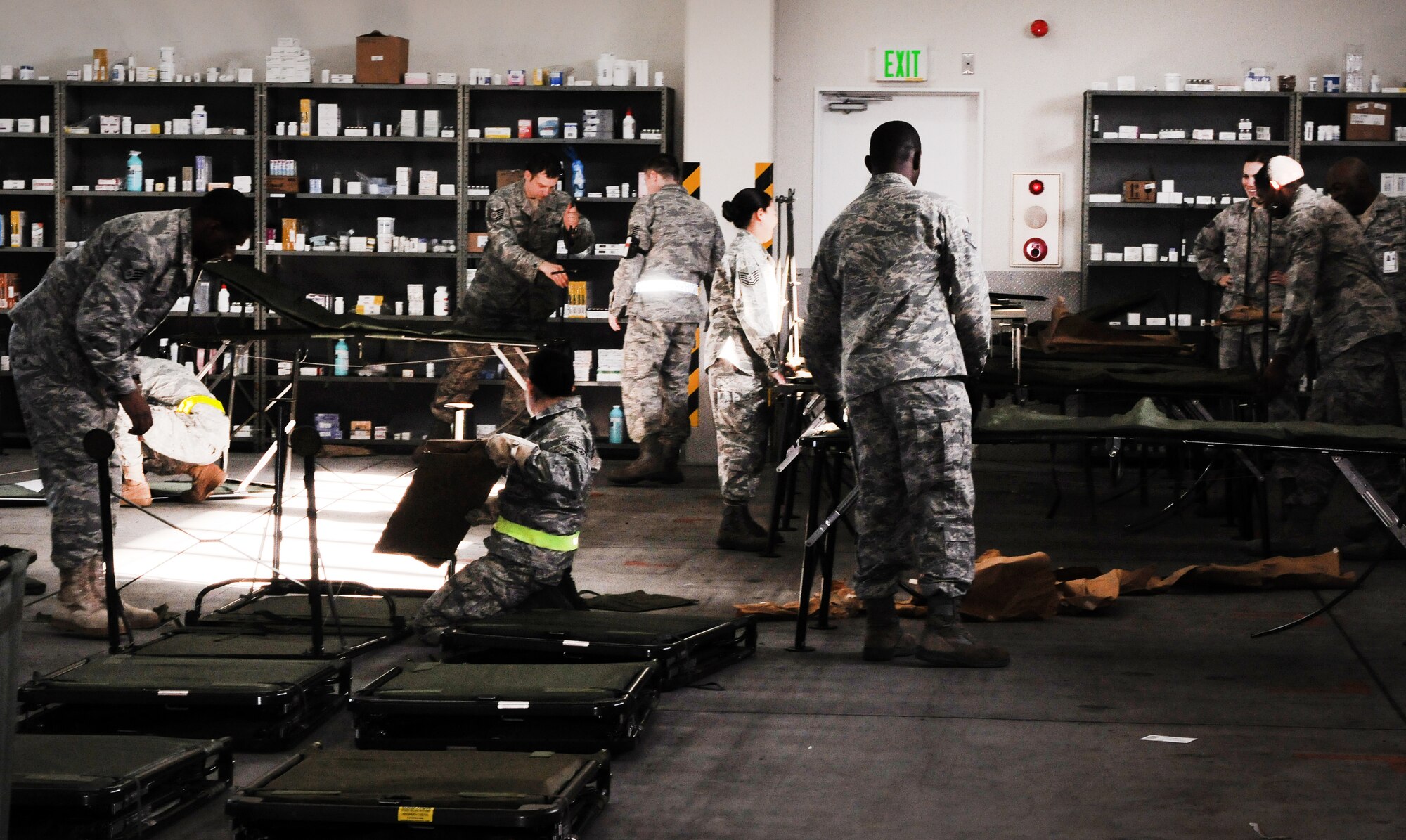 YOKTOA AIR BASE, Japan -- Airmen from the 374th Medical Group put together collapsible patient beds inside the Contingency Aeromedical Staging Facility, during the CASF exercise, here Jan. 18. The exercise was held to teach Yokota's medical personnel how to properly process patients for aeromedical evacuations during a crisis. (U.S. Air Force photo/ A1C Katina R. Menchaca)