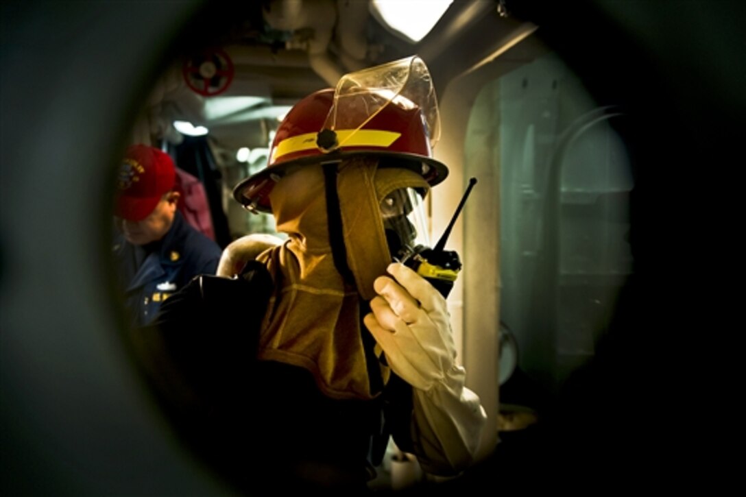 U.S. Navy Petty Officer 3rd Class Crystal Cooper reports a class Alpha fire to her team leader during a firefighting drill aboard the guided-missile destroyer USS Gridley in the Pacific Ocean, Jan. 17, 2011. The Gridley is deployed with the Carl Vinson Carrier Strike Group to the U.S. 7th Fleet area of responsibility.