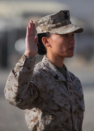 Petty Officer 1st Class Chat Rice, leading petty officer of patient tracker, Health Service Support Element, G-3, 1st Marine Logistics Group (Forward), takes the Oath of Enlistment to dedicate six more years of active duty service to the Navy at Camp Leatherneck, Afghanistan, Jan. 21. Rice is currently deployed in the same unit with her husband of nearly eight years, Marine Staff Sgt. Jeff Rice.