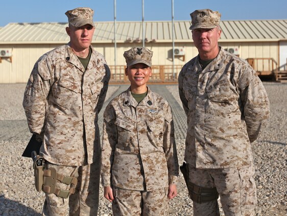 Petty Officer 1st Class Chat Rice (center), leading petty officer of patient tracker, Health Services Support Element, G-3, 1st Marine Logistics Group (Forward), poses with her husband, Staff Sgt. Jeff Rice (left), radio chief and spectrum manager, G-6, 1st MLG (FWD), and Brig. Gen. Charles L. Hudson, commanding general of 1st MLG (FWD), after her reenlistment ceremony at Camp Leatherneck, Afghanistan, Jan. 21. The dual-military couple is currently deployed together in support of Operation Enduring Freedom.