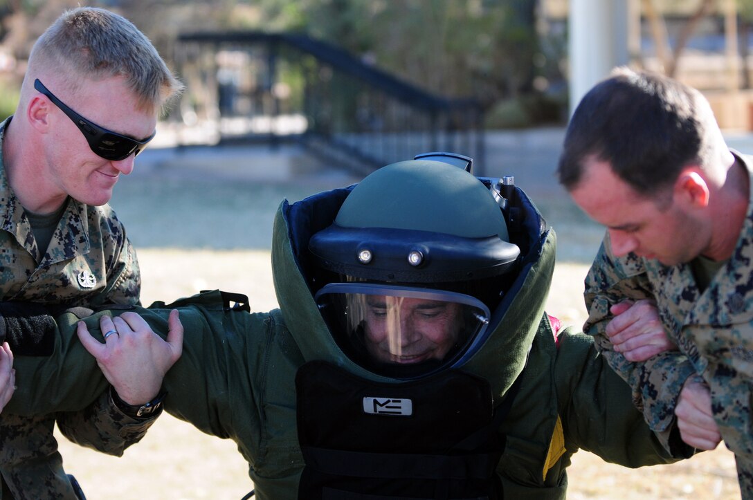 Explosive ordnance disposal technicians Sgt. Dane Schielke, left, and Staff Sgt. Michael Johansson help Barry Michaels into a bomb suit during the first Spirit of Yuma military appreciation festival at the Quartermaster Depot in Yuma, Ariz., Jan. 21, 2011.