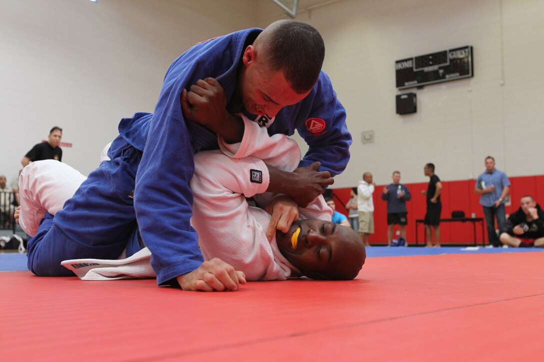 Edwin Nuez, a fighter with Fight Club 29, holds down his opponent during his final match of the tournament at the Armed Forces Grapplers Extreme Tournament at Marine Corps Air Station Miramar, Calif., Jan. 22, 2011. Nuez won the match and earned second place for the tournament.