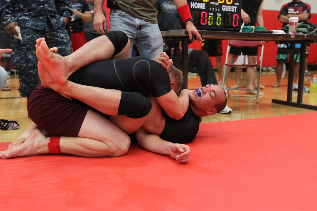 Arthur Powell, a fighter with Fight Club 29, struggles to gain a point on his opponent during overtime at the Armed Forces Grapplers Extreme Tournament at Marine Corps Air Station Miramar, Calif., Jan. 22, 2011. Powell lost the match but earned third place for his weight group.