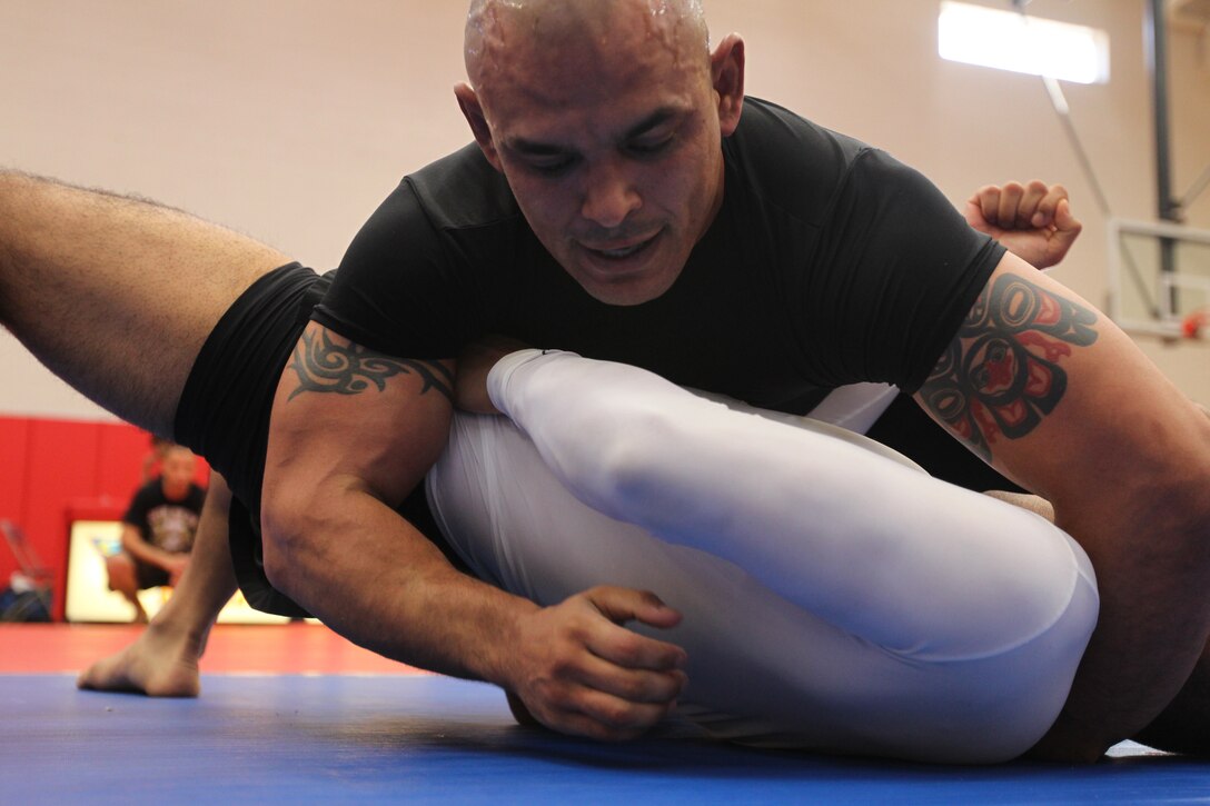James Clark, a fighter with Fight Club 29, goes for a dominate position during his match at Armed Forces Grapplers Extreme Tournament at Marine Corps Air Station Miramar, Calif.,  Jan. 22, 2011. Clark conquered his weight division earning a gold medal.