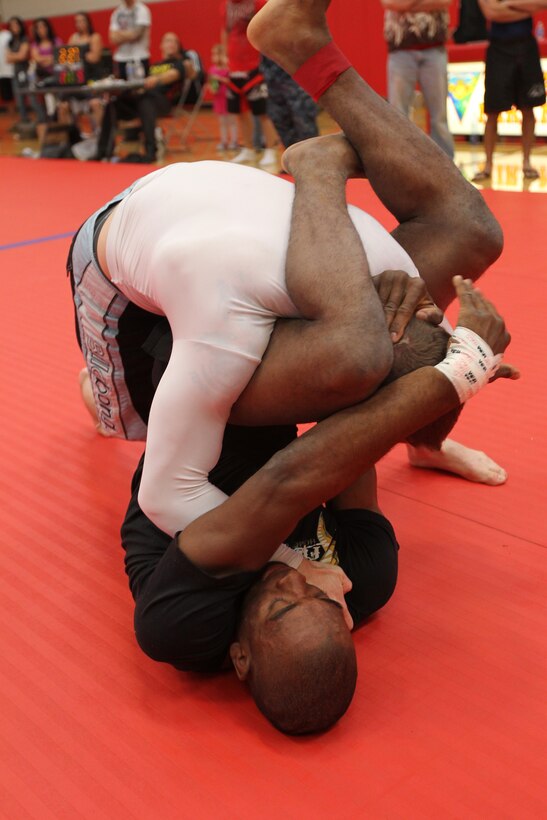 Dominic Waters, a fighter with Fight Club 29, maneuvers his opponent into a hold during a match at the Armed Forces Grapplers Extreme Tournament at Marine Corps Air Station Miramar, Calif., Jan. 22, 2011. Waters forced all his opponents to submit, earning him two gold medals throughout the day.