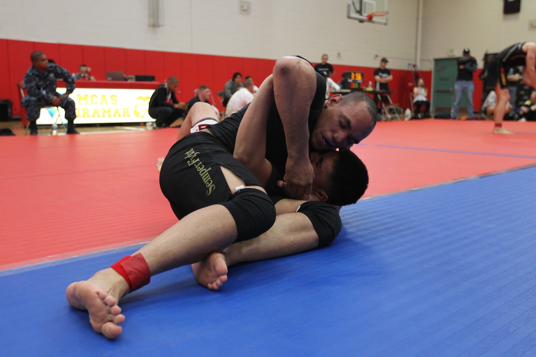Arthur Powell, a fighter with Fight Club 29, hold his opponent in a vice during a match at the Armed Forces Grapplers Extreme Tournament at Marine Corps Air Station Miramar, Calif., Jan. 22, 2011. Powell earned both a gold and bronze medal throughout the day.