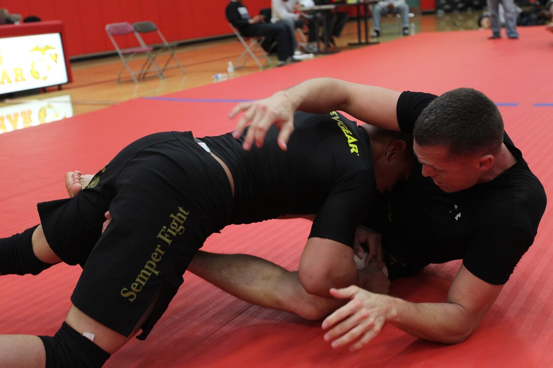 Arthur Powell charges in for a dominate position against Bill Harrington, both fighters with Fight Club 29, for the absolute championship at Armed Forces Grapplers Extreme Tournament at Marine Corps Air Station Miramar, Calif., Jan. 22, 2011.