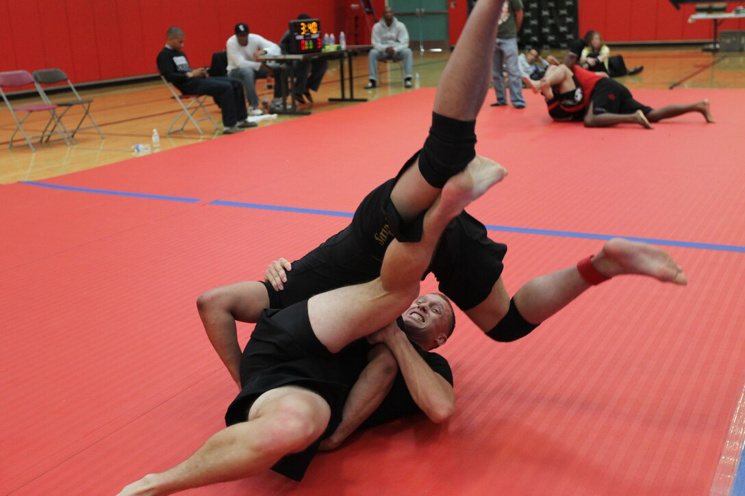 Bill Harrington flips Arthur Powell, both fighters with Fight Club 29, during an absolute match at the Armed Forces Grapplers Extreme Tournament at Marine Corps Air Station Miramar, Calif., Jan. 22, 2011.