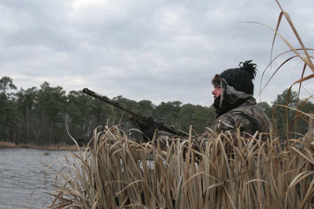 Gunnery Sgt. Timothy Murray from Camp Lejeune’s Wounded Warrior Battalion keeps his eyes open and shotgun ready for ducks flying overhead Jan. 22. Murray said he thinks hunts like this have a therapeutic effect.