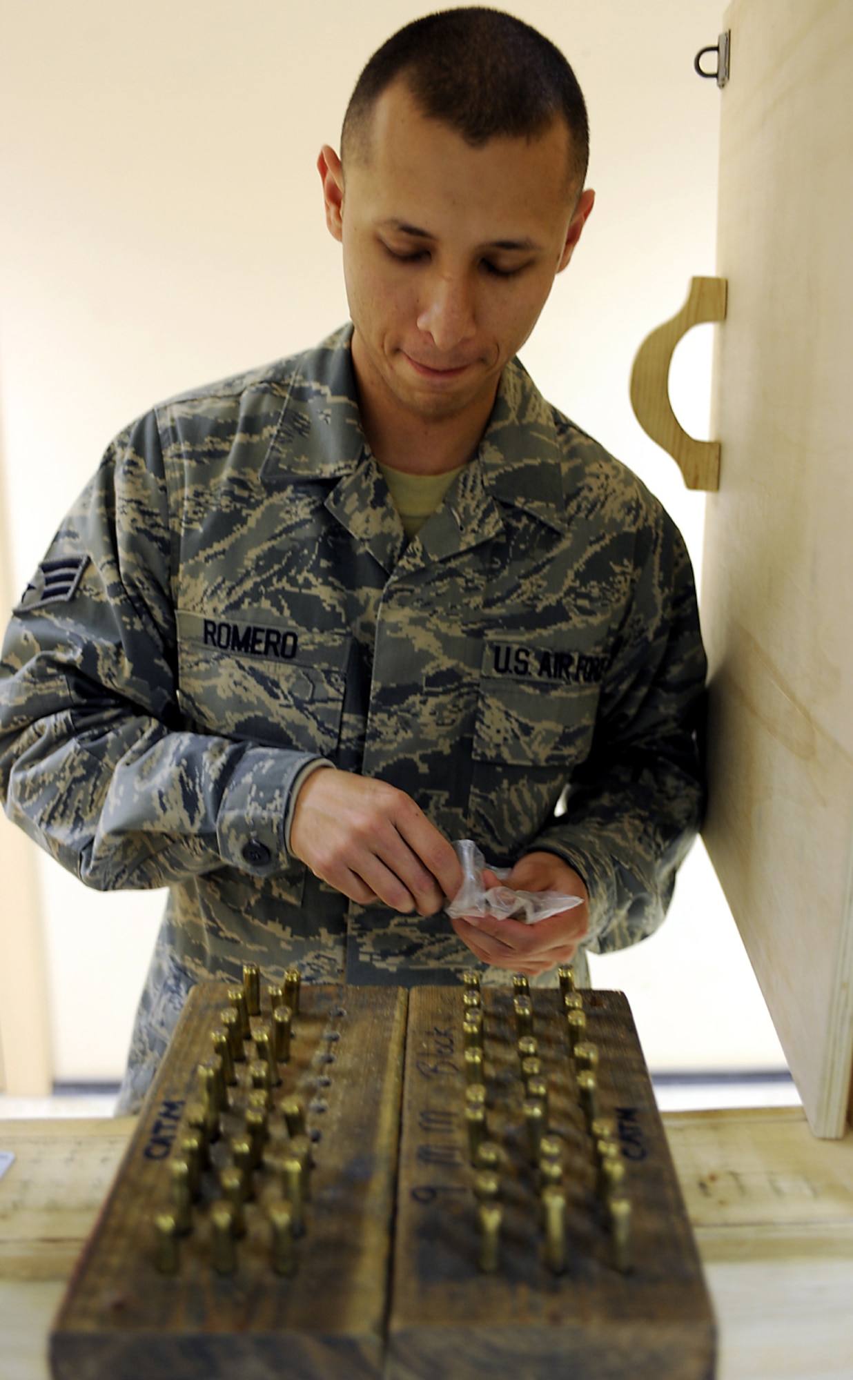 Senior Airman Miguel Romero prepares his 9 mm rounds up for inspection during his ammo turn-in prior to redeploying Jan. 22, 2011, at Kandahar Airfield, Afghanistan. The 451st Expeditionary Security Forces Squadron Combat Arms section is responsible for the inventory of nearly 175,000 9 mm rounds for the M9 pistol, and more than 940,000 of the 5.56 mm rounds for the M16 rifle. Airman Romero is an HH-60G Pave Hawk maintenance analysis journeyman assigned to the 55th Expeditionary Helicopter Maintenance Unit. (U.S. Air Force photo/Senior Airman Willard E. Grande II/Released)