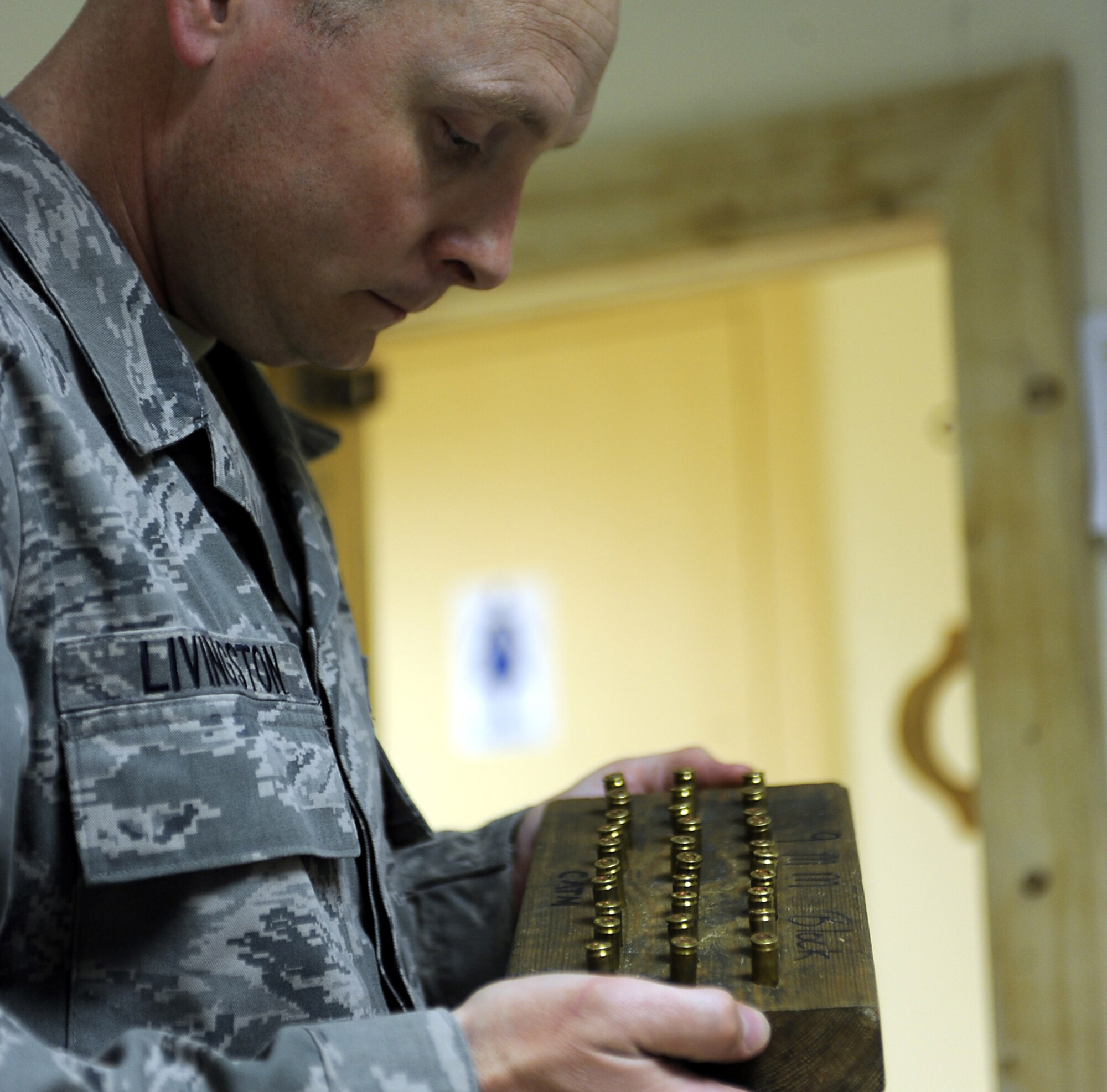 Tech. Sgt. Robert Livingston checks lot numbers on 9 mm rounds Jan. 22, 2011, at Kandahar Airfield, Afghanistan. The 451st Expeditionary Security Forces Squadron Combat Arms team is responsible for the inventory of nearly 175,000 9 mm rounds for the M9 pistol, and more than 940,000 of the 5.56 mm rounds for the M16 rifle. Sergeant Livingston is the 451st ESFS NCO in charge of logistics and combat arms. (U.S. Air Force photo/Senior Airman Willard E. Grande II/Released)