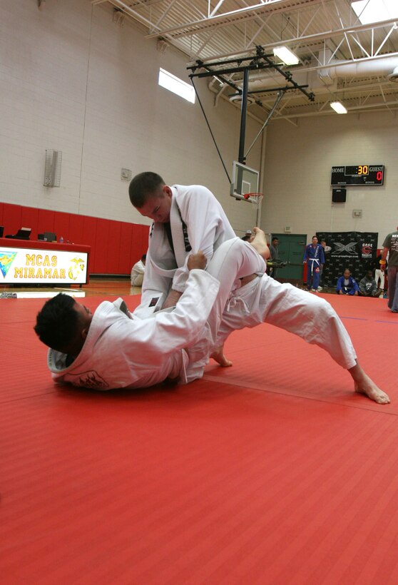 Army medic Sgt. Matthew Lane tries to pin Pfc. Lionel Rodriguez, a motor transportation operator with Combat Logistics Battalion 1, during the Marine Corps Air Station Miramar, Calif., submission grappling tournament Jan. 22. Participants came from military installations across the Southwest to test their grappling mettle.