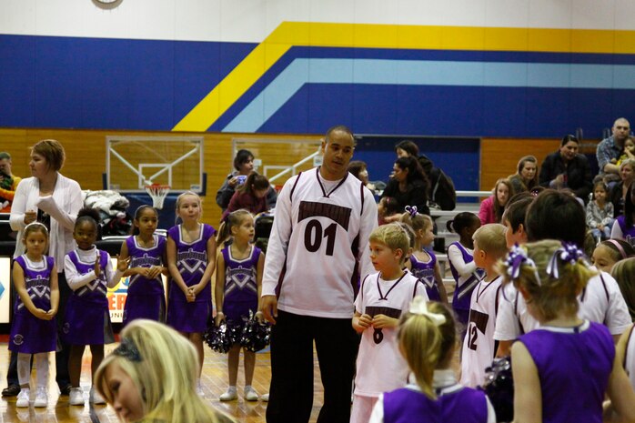 James A. Berry, Iwakuni Heat head coach, stands with his players during their introduction during the opening ceremonies here Jan. 22. The Iwakuni Heat will be practicing often to dominate this season.