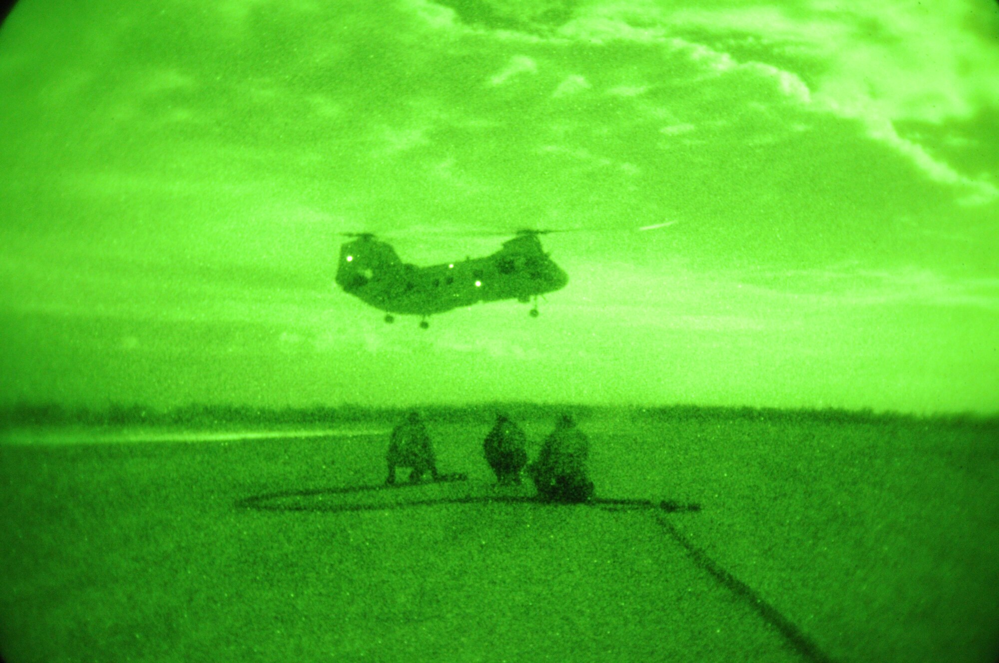 IE SHIMA AIRFIELD, Japan -- Tech. Sgt. Benjamin Turner, Tech Sgt. Timothy Rodgers and Senior Airman Seth San Miguel, all from the 353rd Special Operations Group Forward Area Refueling Point Team, watch as a U.S. Marine Corps CH-46E Sea Knight helicopter lands at a forward area refueling point here Jan. 20 as part of Beverly High 11-02, a local operational readiness exercise. FARP specialists and loadmasters utilize a forward area manifold cart to transfer fuel from one aircraft to another in hostile and austere environments. Members of the 353rd SOG are participating in the exercise to hone their warfighting skills in preparation for a headquarters inspection next month.  (U.S. Air Force photo by Tech. Sgt. Aaron Cram)