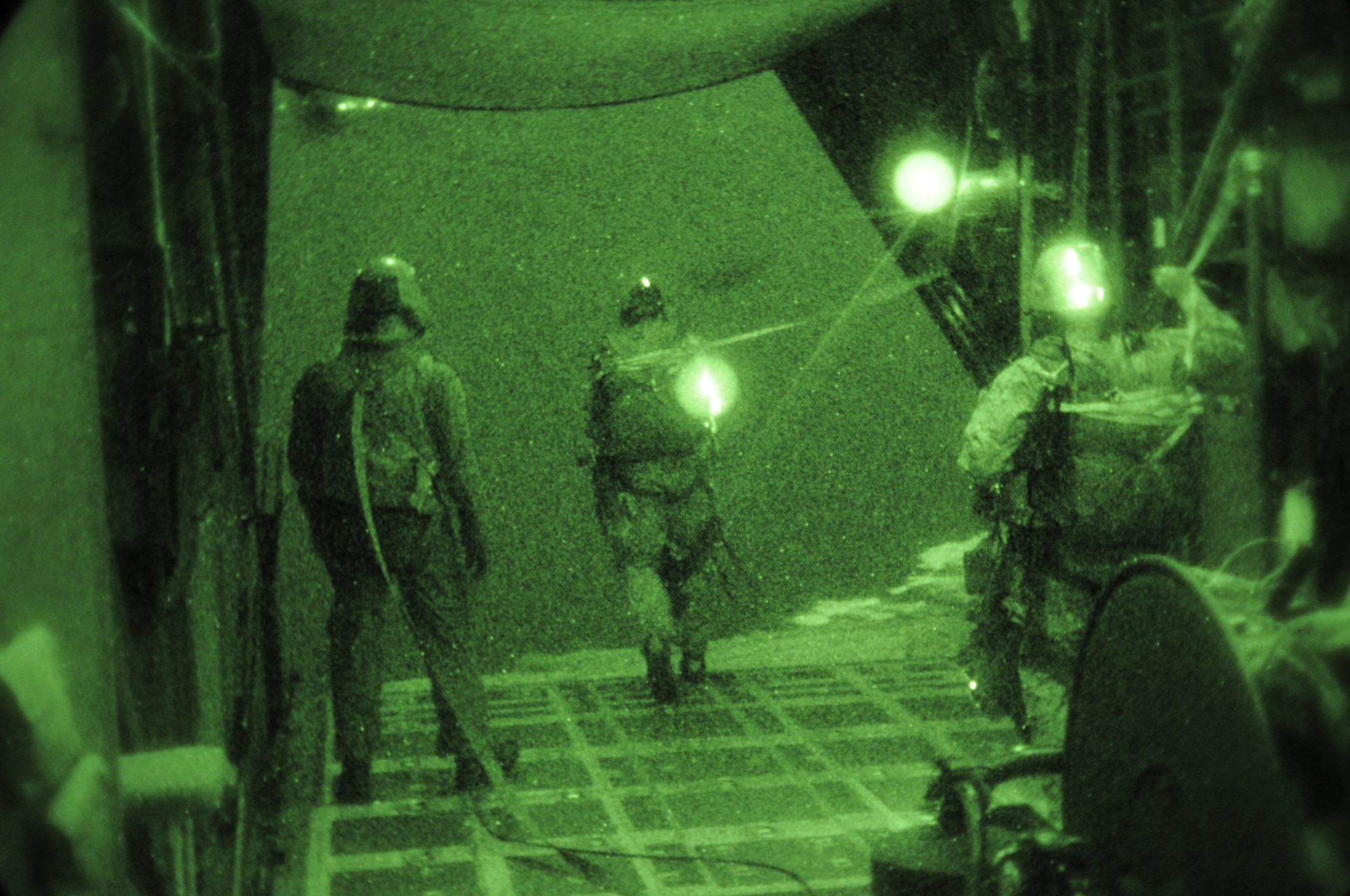 OVER IE SHIMA AIRFIELD, Japan -- Combat controllers from the 320th Special Tactics Squadron parachute from a MC-130H Combat Talon II into "hostile" territory Jan. 20 as part of Beverly High 11-02, a local operational readiness exercise. The team secured the airfield and then controlled the aircraft while it landed at the airfield. Combat Controllers are trained special operations forces and certified FAA air traffic controllers. Members of the 353rd Special Operations Group are participating in the exercise to hone their warfighting skills in preparation for a headquarters inspection next month. (U.S. Air Force photo by Tech. Sgt. Aaron Cram)