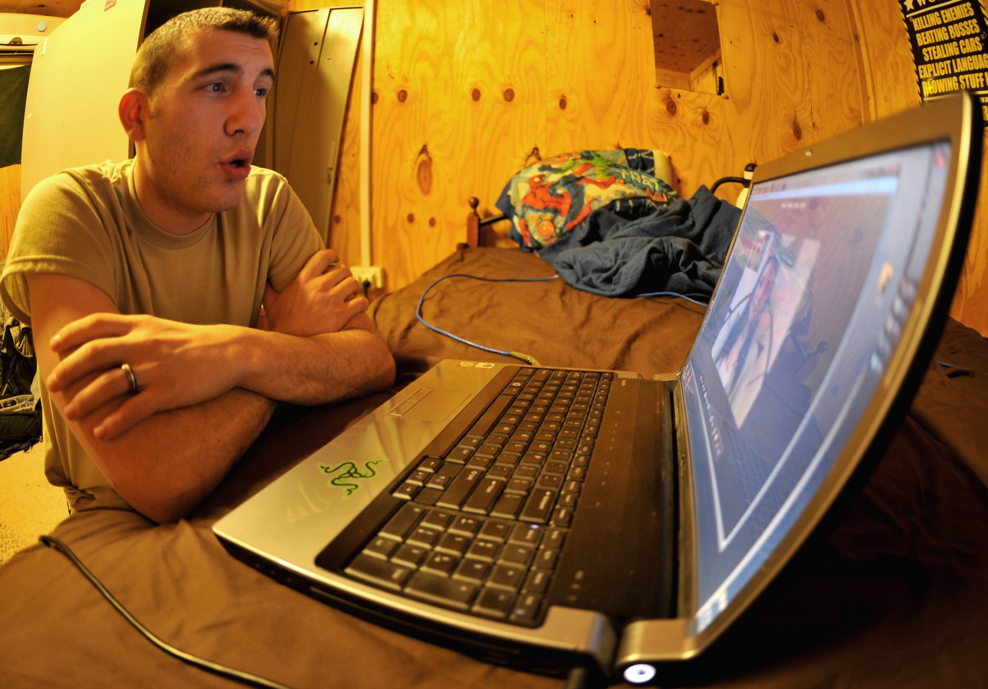 U.S. Air Force Senior Airman Nicholas Rogers, service desk analyst with Contingency Operating Base Speicher’s direct support signal team, talks to his wife, Kayla Rogers, through a web camera Jan. 22, 2011. The Gallatin, Mo., native is deployed to Iraq from the 375th Communications Squadron at Scott Air Force Base, Ill. (U.S. Air Force photo by Senior Airman Andrew Lee)