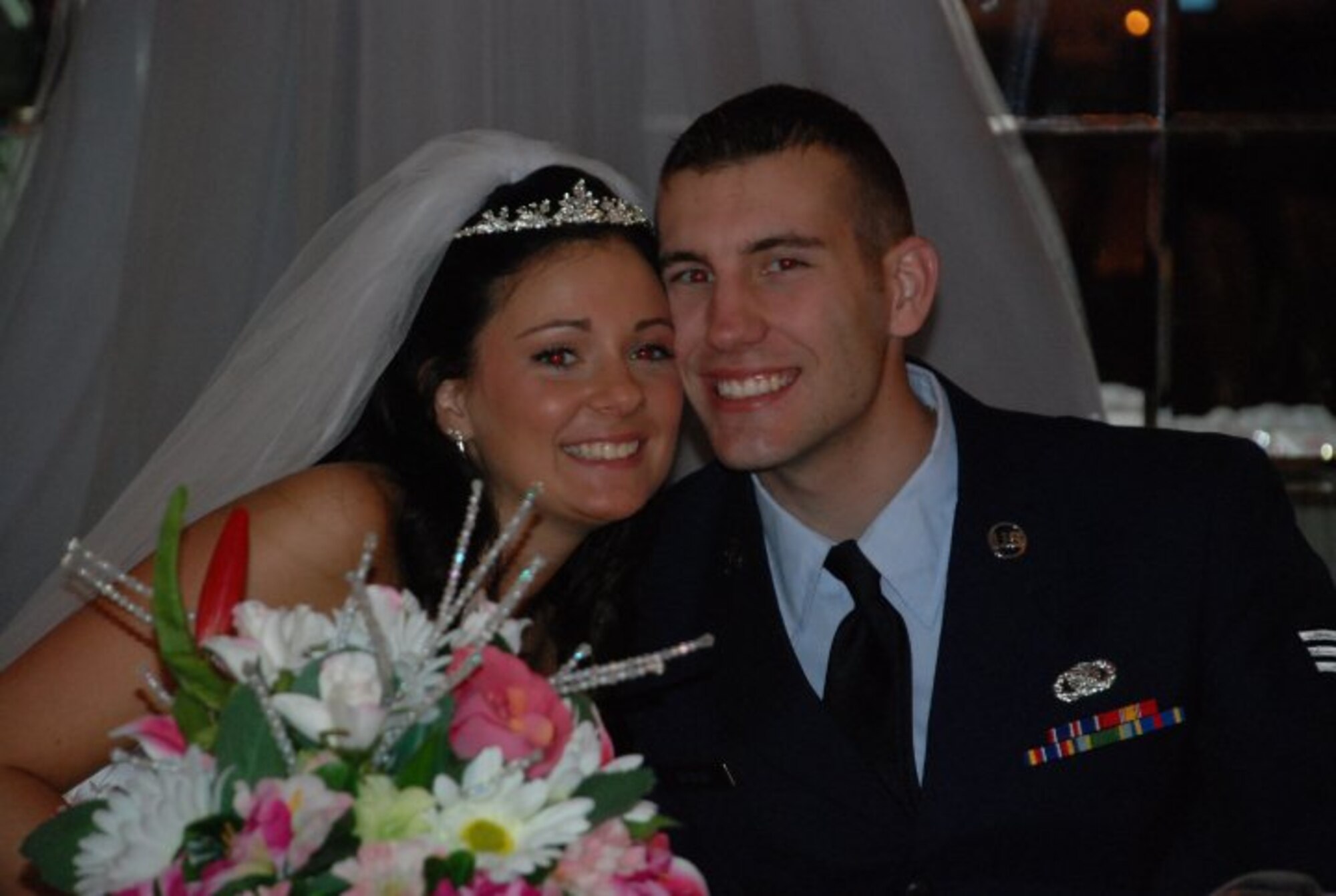 U.S. Air Force Senior Airman Nicholas Rogers, service desk analyst with Contingency Operating Base Speicher’s direct support signal team, poses for a photo with his wife, Kayla Rogers, during their wedding reception May 15, 2010. The Gallatin, Mo., native is deployed to Iraq from the 375th Communications Squadron at Scott Air Force Base, Ill. (Courtesy photo)
