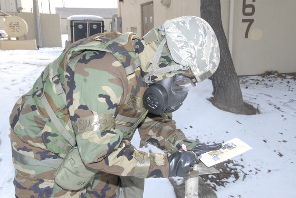 KUNSAN AIR BASE, Republic of Korea -- Staff Sgt. Danyette Washington, 8th Civil Engineer Squadron, properly marks simulated M8 paper using the Kunsan Air Base Ability To Survive and Operate guide as a reference. The Kunsan AB ATSO guide was developed to enhance the Wolf Pack's ability to survive and operate in a chemical, biological, radiological or nuclear environment. (U.S. Air Force photo/Staff Sgt. Amanda Savannah) 