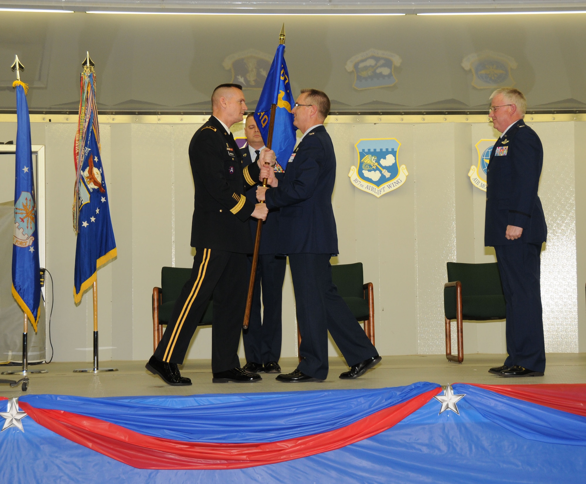On Jan 22nd in a ceremony attended by more than 1,000 military members, family, and friends, Colonel Jim McCready assumed command of the 107th Airlift Wing. New York State Adjutant General, Maj. Gen. Patrick Murphy (on left) passes the Wing's colors to the new commander as the outgoing 107th AW Commander (on right) Col. Patrick Ginavan looks on. Well suited for the new challenge, Col. McCready previously served as the wing's vice commander, responsible for equipping and training the wing?s 800 Airmen. "I'm honored to be the next wing commander of the 107th, it?s a great challenge, we have a great wing with incredibly talented individuals and I look forward to leading them into the next chapter for the wing," said Col McCready. (U.S. Air Force photo/Senior Master Sgt. Ray Lloyd)