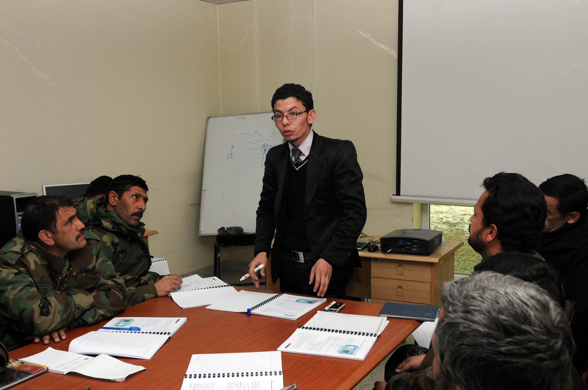 KABUL, Afghanistan - Afghan Instructor Ahmed Jaweed Muslim teaches members of the Afghan Air Force a new computer training course called A+ training at the Afghan Air Force Base in Kabul, Afghanistan Jan.17. (U.S. Navy photo by Mass Communications Specialist 3rd Class Petty Officer Jared E. Walker/ RELEASED).