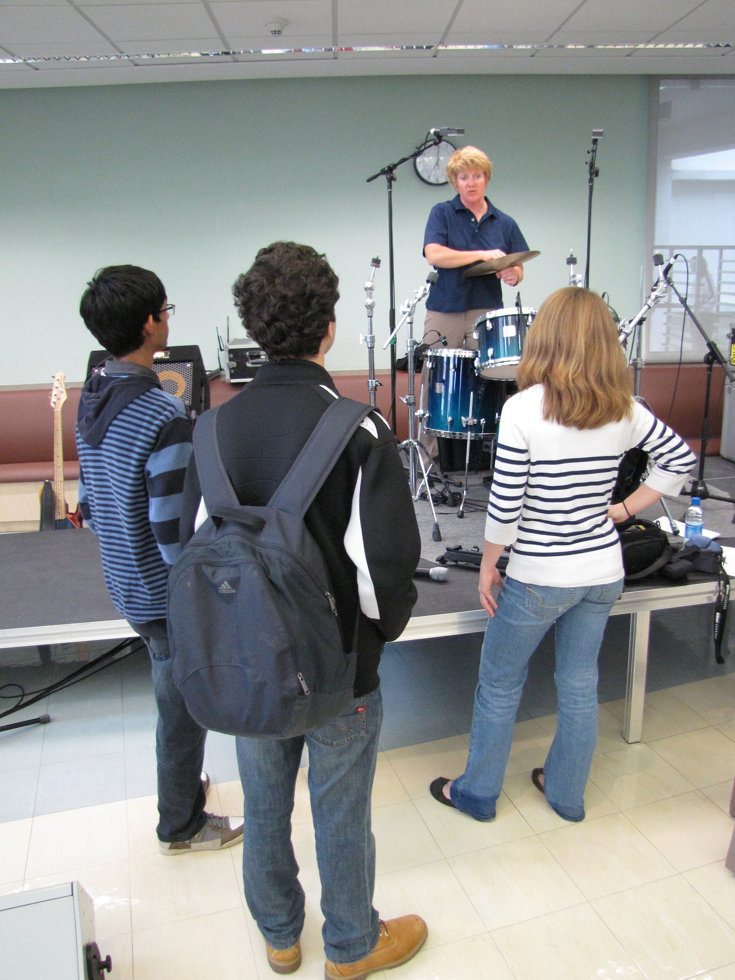 Music students of an American secondary school at an undisclosed location in Southwest Asia get the opportunity to speak with drummer, Tech. Sgt. Christi McGowan, after a performance by Starlifter, the U.S. Air Forces Central Band, Jan. 19. (U.S. Air Force photo by Staff Sgt. Angelique N. Smythe) 