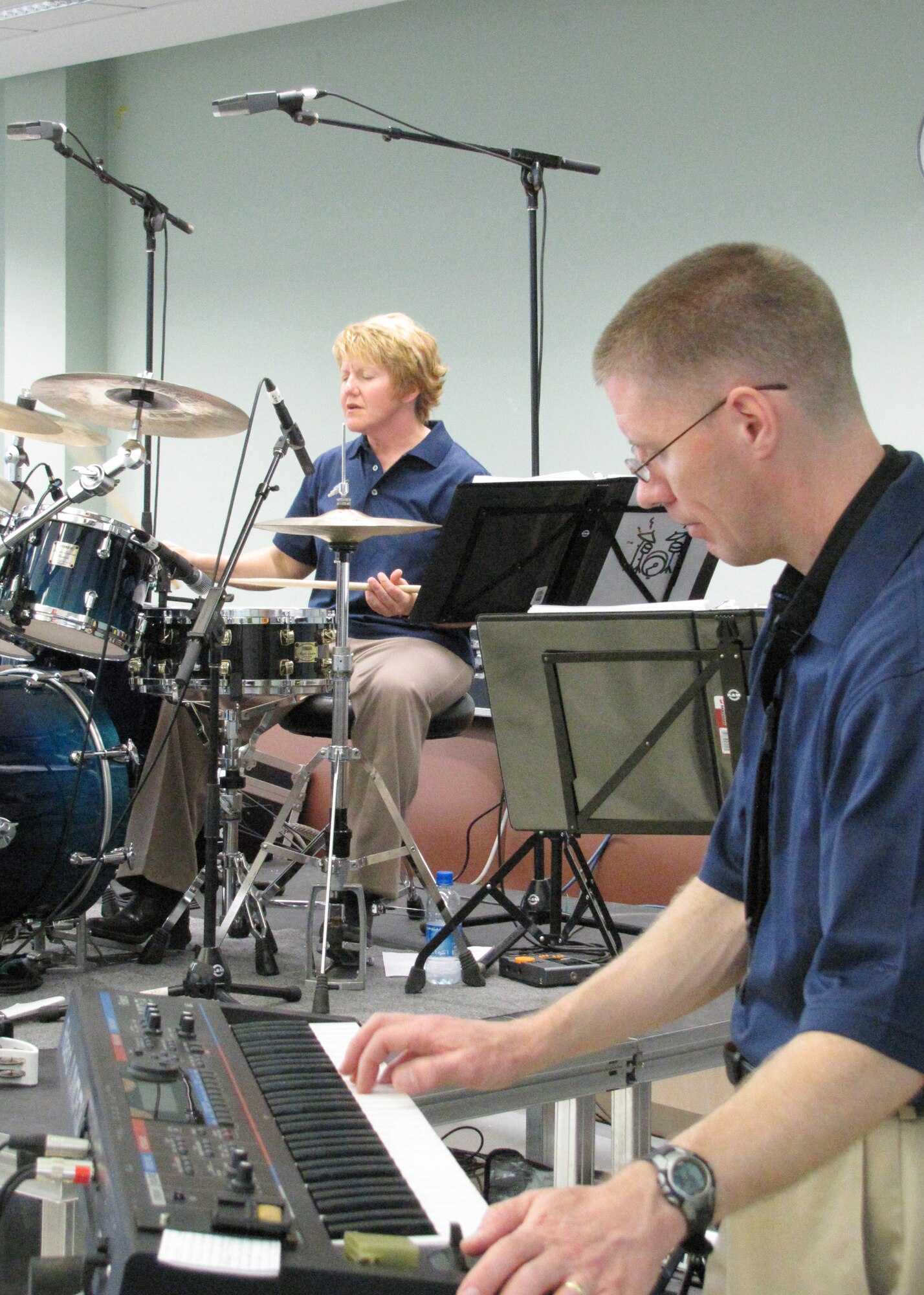 Keboard player, Tech. Sgt. Dwight West, and drummer, Tech. Sgt. Christi McGowan, perform with the U.S. Air Forces Central Band, Starlifter, for approximately 600 students in an American secondary school at an undisclosed location in Southwest Asia, Jan. 19. (U.S. Air Force photo by Staff Sgt. Angelique N. Smythe)
