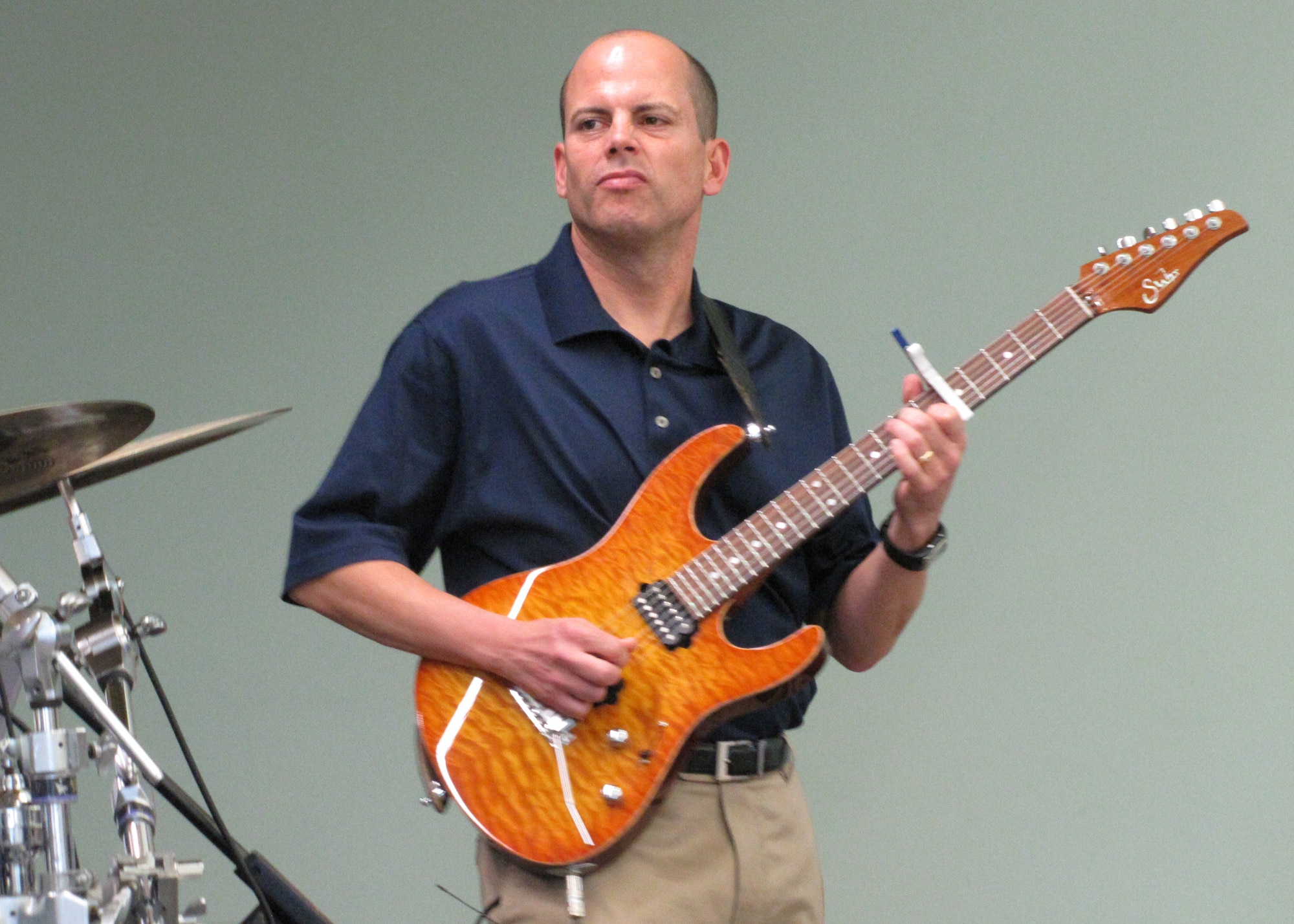 Master Sgt. Jerry Kelley plays his guitar during a performance put on by the U.S. Air Forces Band Starlifter for approximately 600 students in an American secondary school at an undisclosed location in Southwest Asia, Jan. 19. (U.S. Air Forces photo by Staff Sgt. Angelique N. Smythe)
