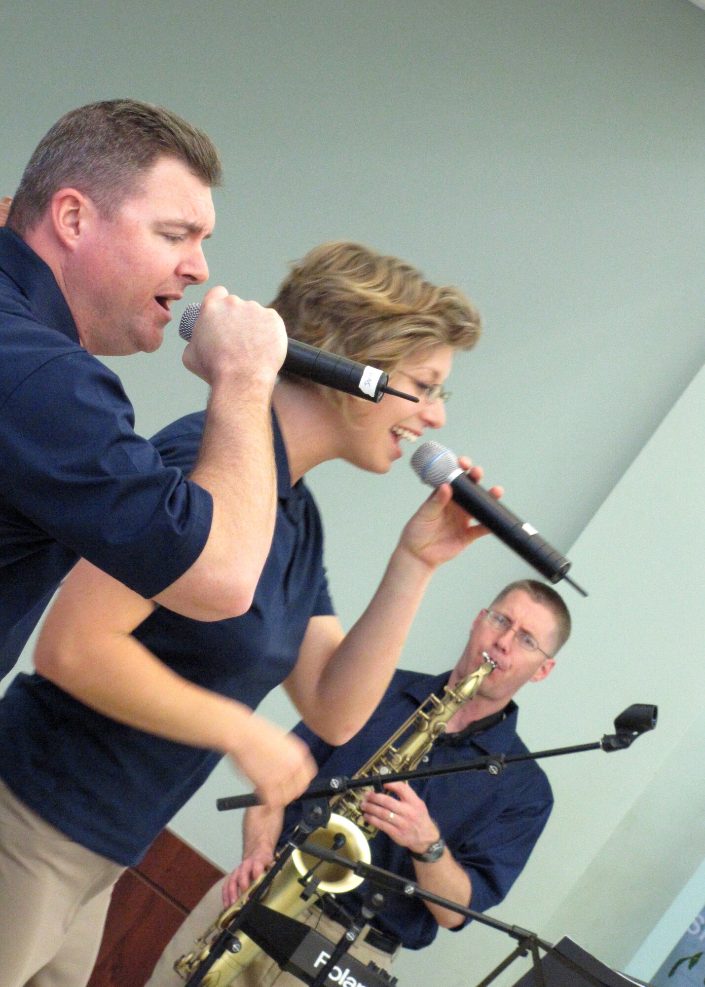 Vocalists of the U.S. Air Forces Central Band Starlifter, Tech. Sgt. Jamie Gilley and Airman 1st Class Carmen Emborski, and saxophonist, Tech. Sgt. Dwight West, perform for approximately 600 students in an American secondary school at an undisclosed location in Southwest Asia, Jan. 19.  (U.S. Air Force photo by Staff Sgt. Angelique N. Smythe)
