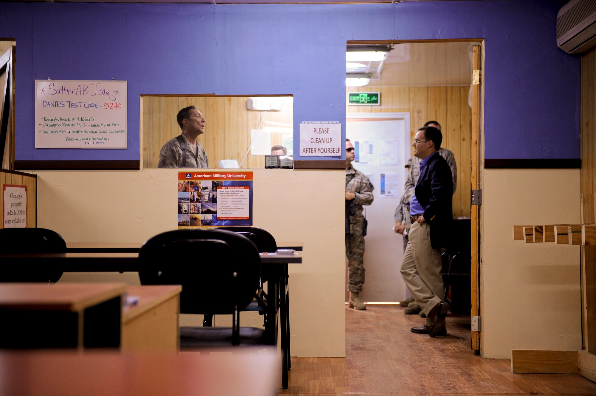 U.S Air Force Master Sgt. George Piper, 447th Air Expeditionary Group test control officer,speaks about education office services with Daniel Ginsberg, the Assistant Secretary of the Air Force for Manpower and Reserve Affairs, Sather Air Base, in Baghdad, Iraq, Jan. 21. Assistant Secretary Ginsberg was touring Iraq to discuss the Air Force's progress in the drawdown of U.S. forces in country. (U.S. Air Force photo by Staff Sgt. Levi Riendeau)