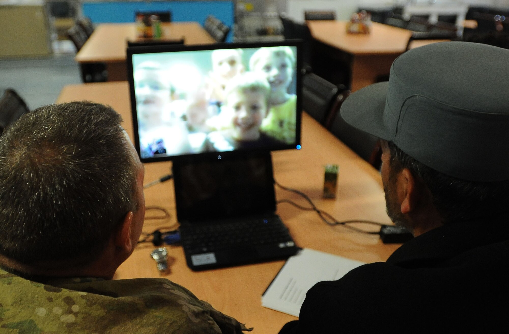 U.S. Army Master Sgt. Todd Eipperle, senior non-commissioned officer in charge of Task Force Red Bulls Embedded Training Team in Panjshir, and Marshalltown, Iowa, native (left), and Capt. Sefat Mire, Afghan National Police training officer for Rokha District (right), speak with Cub Scouts via Skype here Jan. 22. Cub Scouts from Pack 182, located in Ankeny, Iowa, were able to ask the ANP officer several questions about his life in Afghanistan. (Photo by U.S. Air Force Senior Airman Amber Ashcraft)