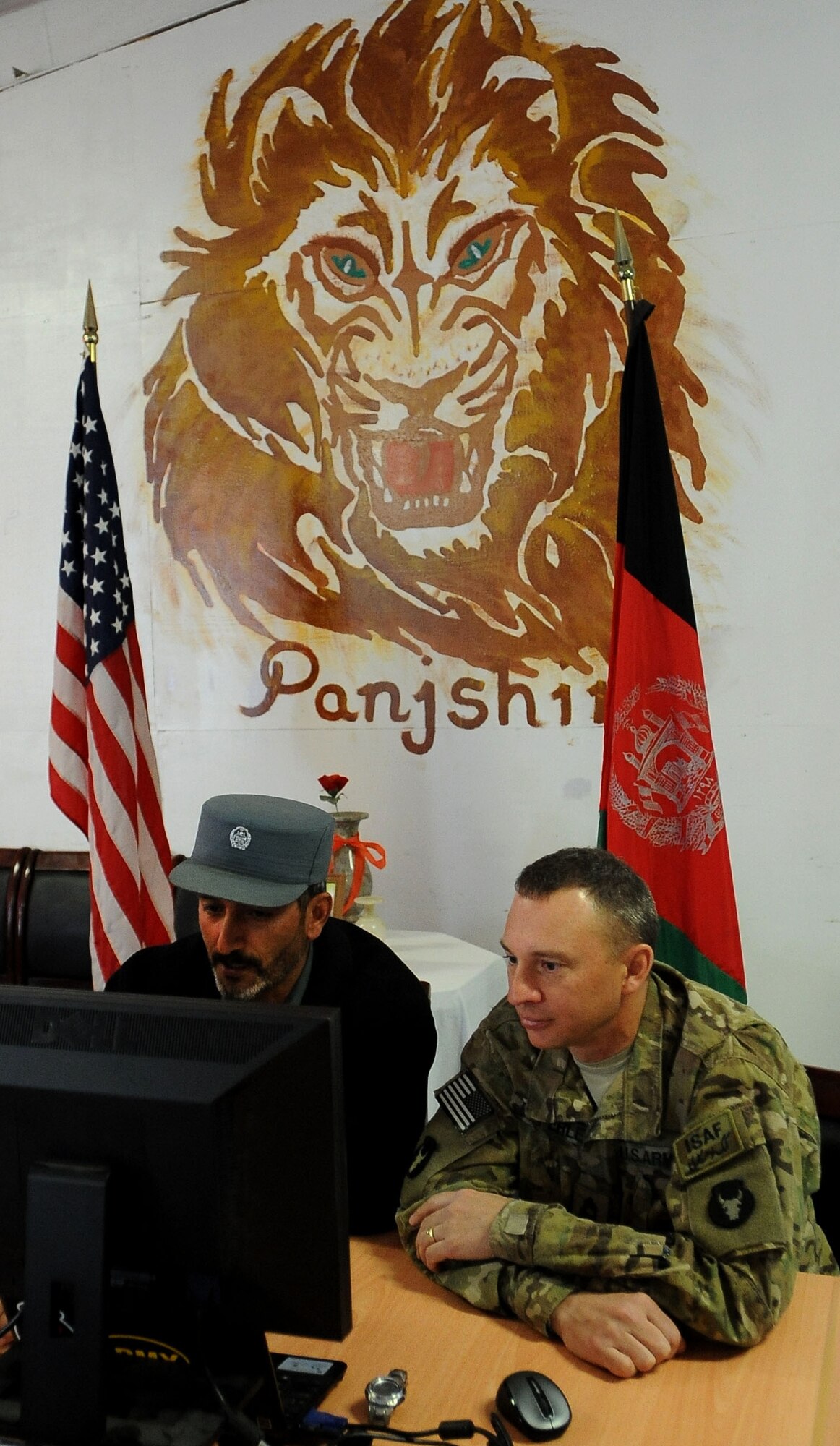 Capt. Sefat Mire, Afghan National Police training officer for Rokha District, and U.S. Army Master Sgt. Todd Eipperle, senior non-commissioned officer in charge of Task Force Red Bulls Embedded Training Team in Panjshir, and Marshalltown, Iowa, native, speak with Cub Scouts via Skype here Jan. 22. Cub Scouts from Pack 182, located in Ankeny, Iowa, were able to ask the ANP officer several questions about his life in Afghanistan. (Photo by U.S. Air Force Senior Airman Amber Ashcraft)
