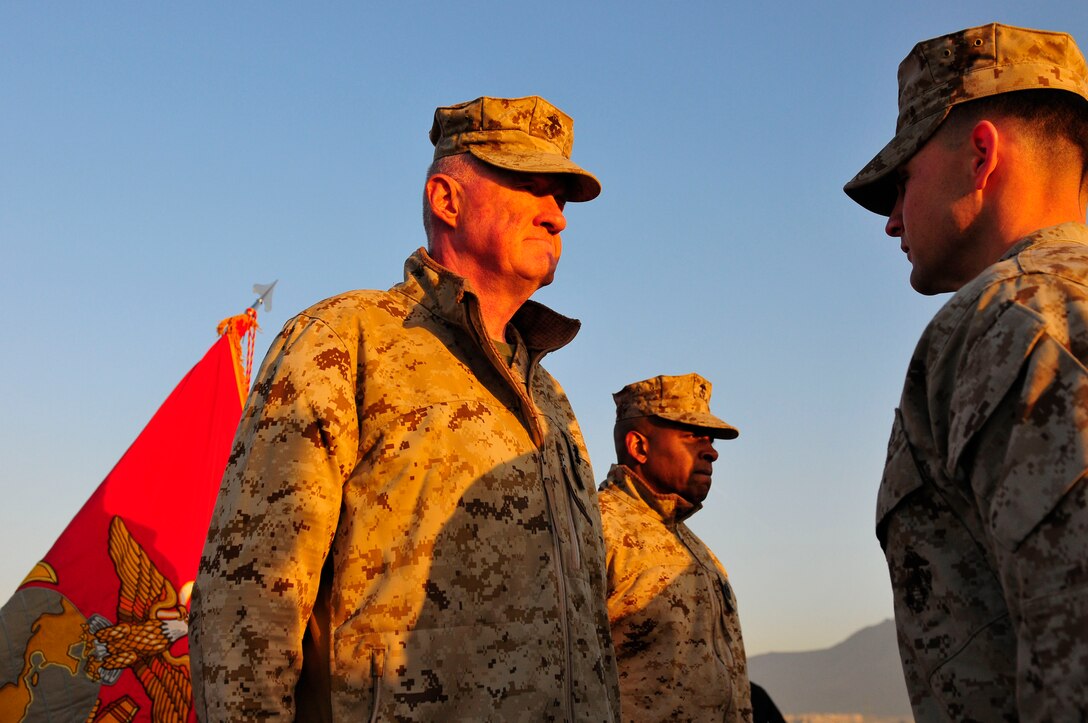 Maj. Gen. Richard Mills, commander of Regional Command Southwest, promotes 1st Lt. Daniel Housinger and 1st Lt. Brandon Williams to the rank of captain on the roof of the Marine House at the Kabul International Airport, Jan 24.