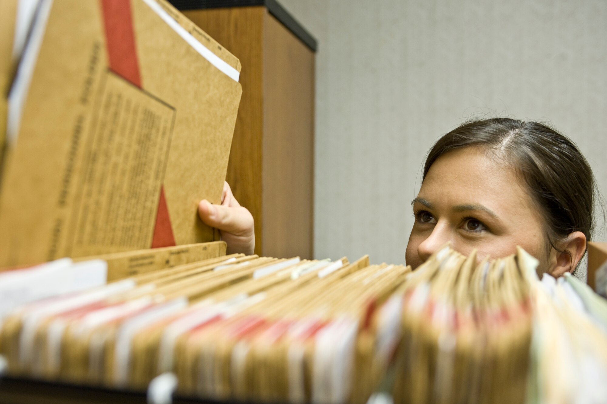 Senior Airman Amanda Harmon, 2nd Force Support Squadron formal training manager, pulls a customer file at the education center on Barksdale Air Force Base, La., Jan. 24. The formal training section handles processing and orders for training courses including the NCO Academy, Senior NCO Academy, Squadron Officer School and retraining. (U.S. Air Force photo/Senior Airman Chad Warren)(RELEASED)