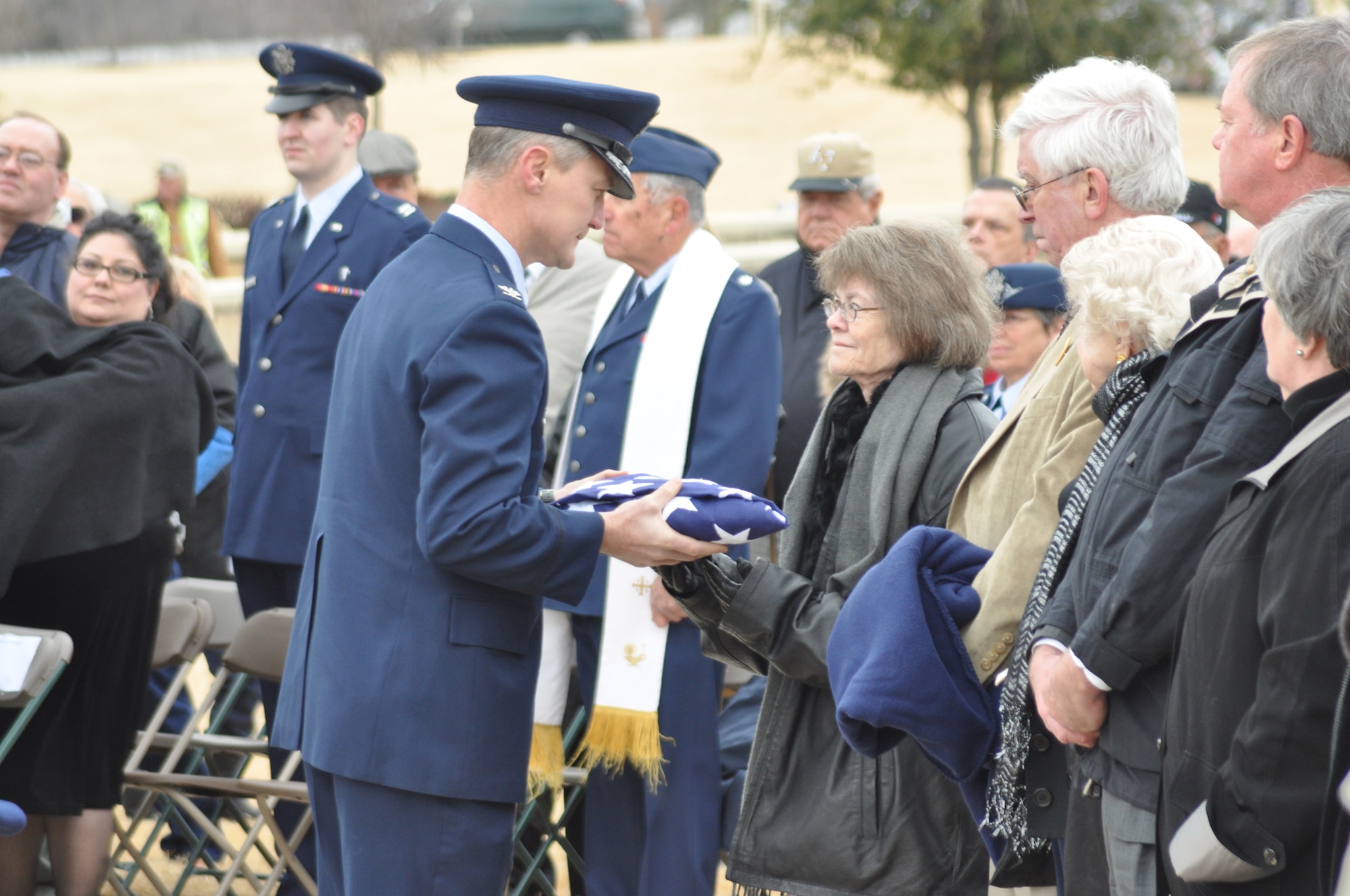 Col. John W. Pearse, commander of the 35th Operations Group, 35th Fighter Wing at Misawa Air Base, Japan presents the United States flag to Mrs. Sharon Tucci, wife of the late Maj. Robert L. Tucci. Col. James E. Dennany, along with Maj. Tucci had been missing since Nov. 12 1969 when their F-4 went down during a mission over Laos. (U.S. Air Force photo/SrA Melissa Harvey)