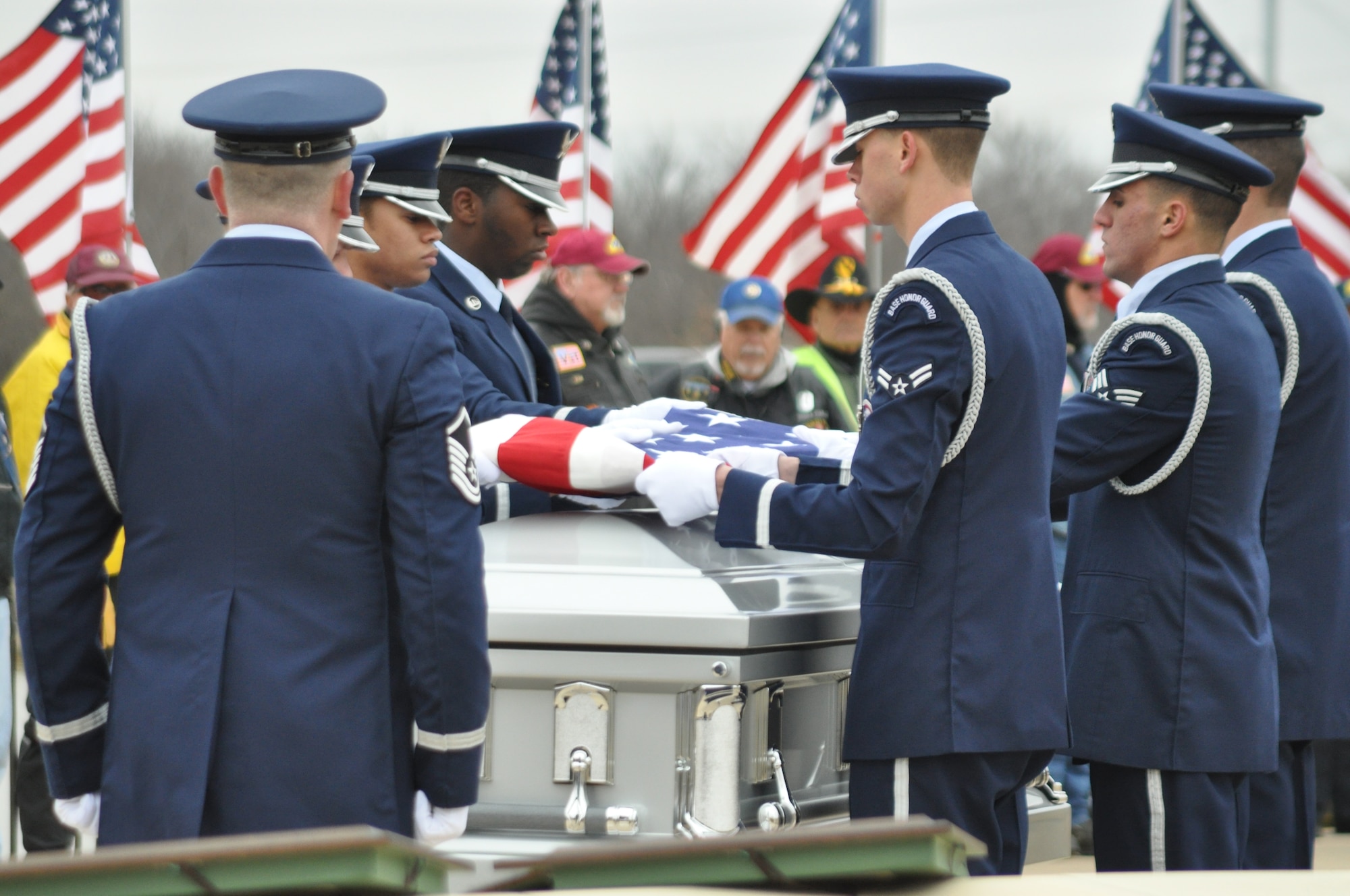 Members of the Honor Guard at Dyess Air Force Base, Texas reverently fold the United States flag over the remains of Col. James E. Dennany and Maj. Robert L. Tucci Jan 14. 2011 at Dallas-Fort Worth National Cemetery . The two Airmen were reported missing in action after their F-4 went down during a mission over Laos Nov. 12, 1969. (U.S. Air Force photo/SrA Melissa Harvey)