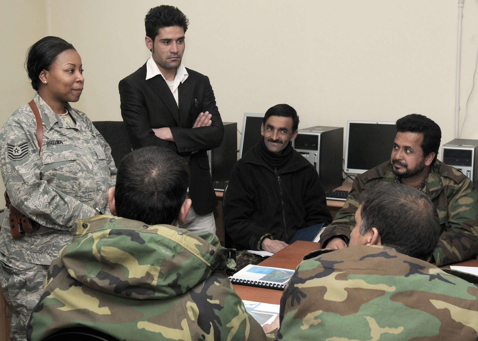 Tech. Sgt. Tara Brown talks to members of the Afghan air force who are part of a new computer training course called A+ training at the Afghan Air Force Base Jan. 17, 2011, in Kabul, Afghanistan. Sergeant Brown is a NATO Air Training Command-Afghanistan communication adviser. (U.S. Navy photo/Petty Officer 3rd Class Jared E. Walker)