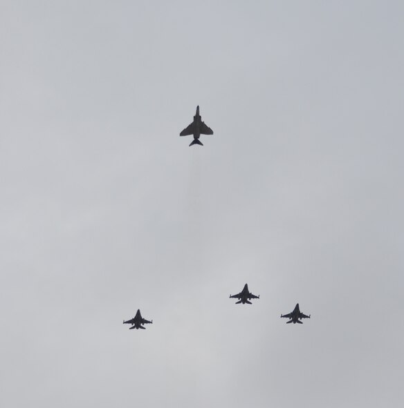 Three F-16s from the 457th Fighter Squadron based at Naval Air Station Fort Worth Joint Reserve Base, Texas and One F-4 from Detachment 1, 82nd Aerial Targets Squadron at Holloman Air Force Base, New Mexico flyover a memorial service Jan. 14, 2011 at Dallas-Fort Worth National Cemetery. The service honored Col. James E. Dennany and Maj. Robert L. Tucci, who were reported missing in action after their F-4 went down during a mission over Laos Nov. 12, 1969. (U.S. Air Force photo/SrA Melissa Harvey)