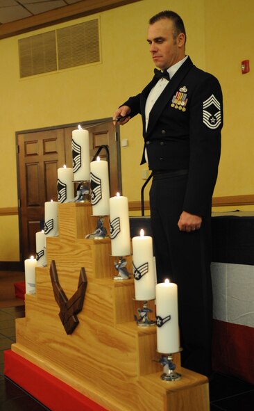 Chief Master Sgt. James Martin, Barksdale?s Chiefs? Group vice president, lights the chief master sergeant candle during the Chief Master Sergeant Recognition Ceremony held at the Barksdale Club, Jan. 21. The candles have a stripe of each enlisted rank. The master of ceremony spoke about each rank?s history as they were lit. (U.S. Air Force photo/ Senior Airman Alexandra M. Boutte) (RELEASED)