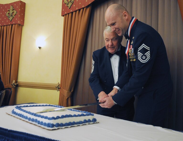 Chief Master Sgt. of the Air Force #5 Robert Gaylor and Chief Master Sgt. (Sel) Robert Hoyt, Air Force Global Strike Command, cut the cake at the Barksdale Club, Jan. 21 during the Chief Master Sergeant Recognition Ceremony. The senior and junior ranking chief master sergeants were chosen to cut the cake. (U.S. Air Force photo/ Senior Airman Alexandra M. Boutte) (RELEASED)