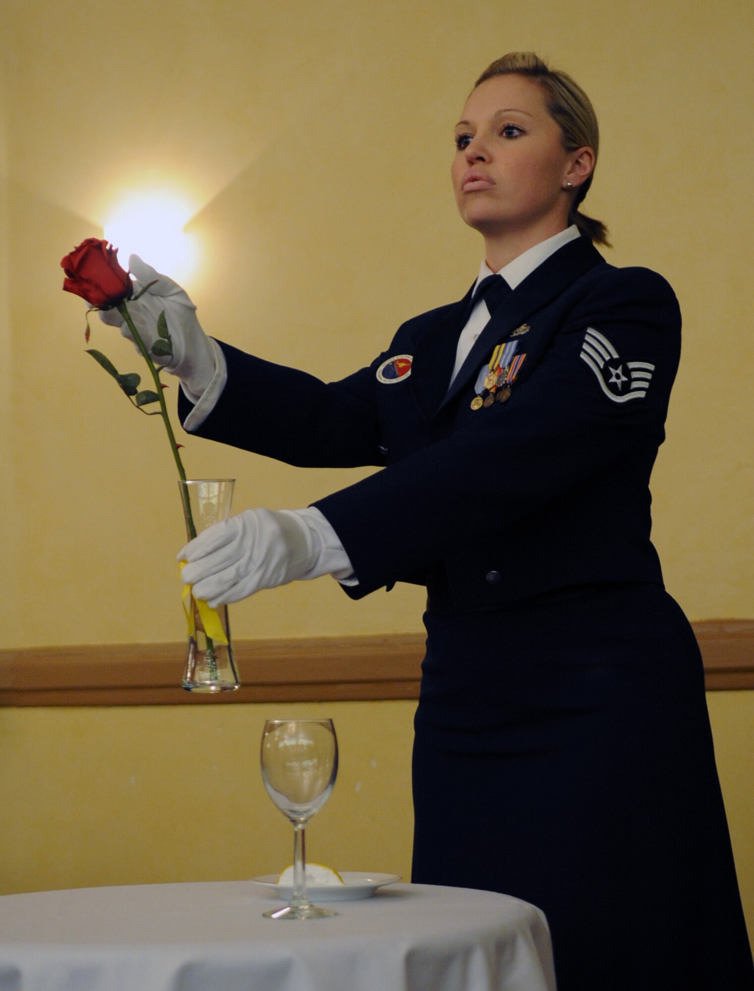 Staff Sgt. Allison Cain, Airman Leadership School instructor, presents the Prisoners of War/ Missing in Action table during the Chief Master Sergeant Recognition Ceremony at the Barksdale Club, Jan. 21. The single rose displayed in a vase reminds Airman of the families and loved ones of comrades in arms who keep faith awaiting their return. (U.S. Air Force photo/ Senior Airman Alexandra M. Boutte) (RELEASED)