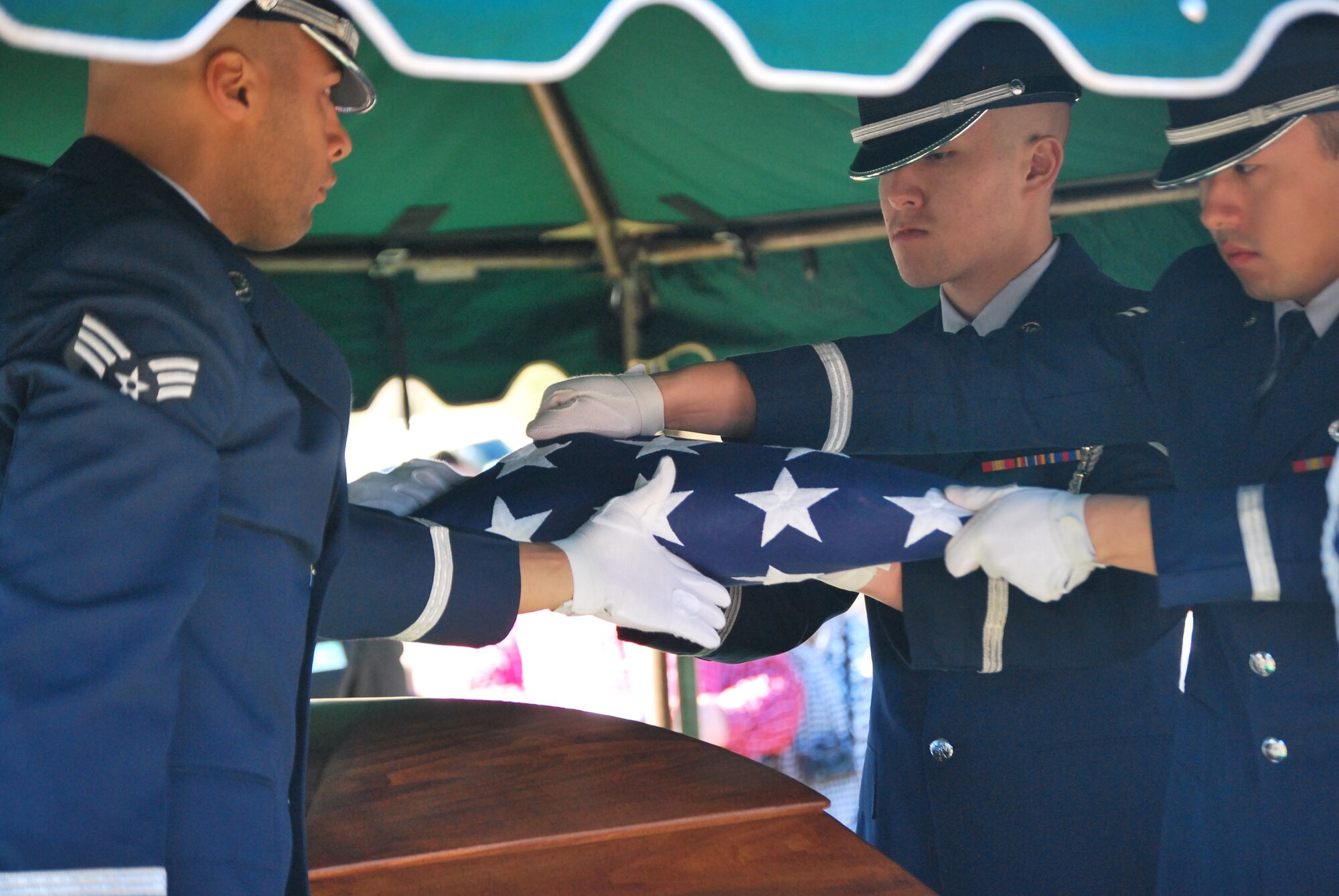 Honor Guard from Eglin Air Force Base folds the flag from the coffin of 1st Lt. Robert Franklin Dees in Ozark, Ala.. The flag was presented to Ms. Linda K. Dees, niece of the missing Airman. (U.S. Air Force photo/Van Williams)