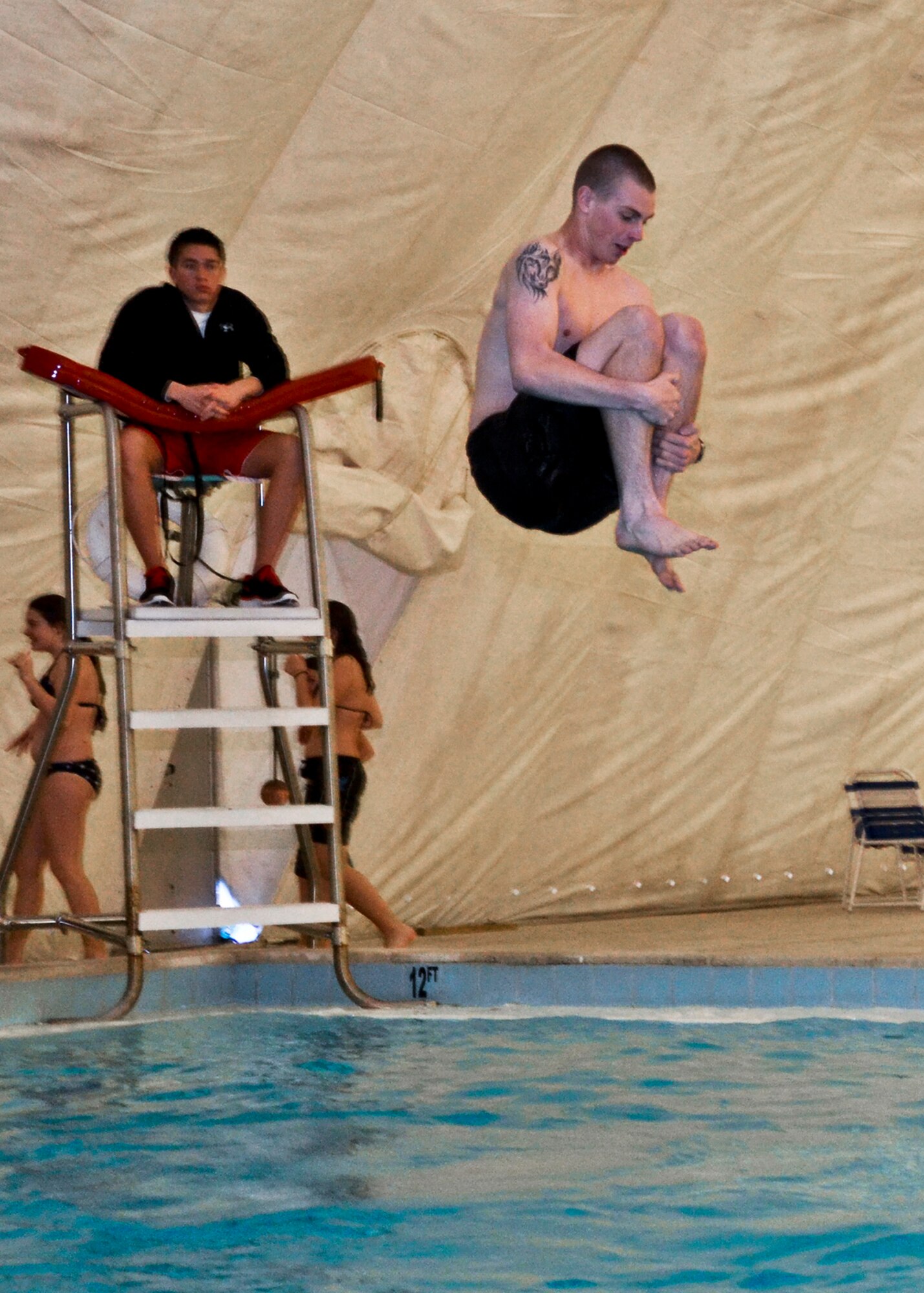 Cole Ford holds on tight hoping to make a big splash in the cannonball contest Jan. 24 at the Eglin pool. People enjoyed free music, food, and games like water basketball and volleyball during the winter pool party.  (U.S. Air Force Photo/Sachel Seabrook) 
