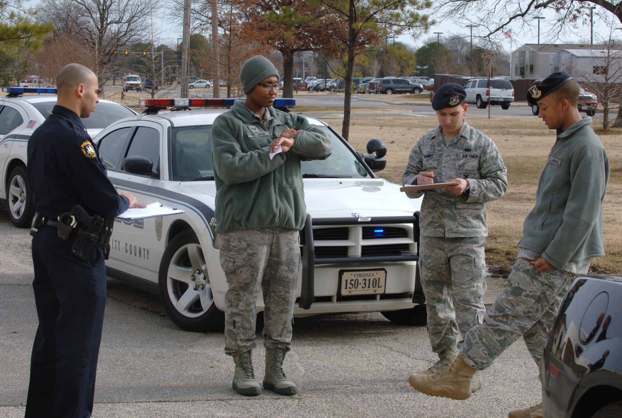 LANGLEY AIR FORCE BASE, Va. -- James City County Master Police Officer Marc Marchand (left) observes Airmen from the 633d Security Forces Squadron perform a field sobriety test during a training exercise Jan. 20 at Herron Hall. The JCC Police Department provided expert officers to train security forces personnel how to perform the test and apprehend impaired drivers, which are requirements for all law enforcement officers operating in Virginia. (U.S. Air Force photo/Airman 1st Class Jason J. Brown)(RELEASED)