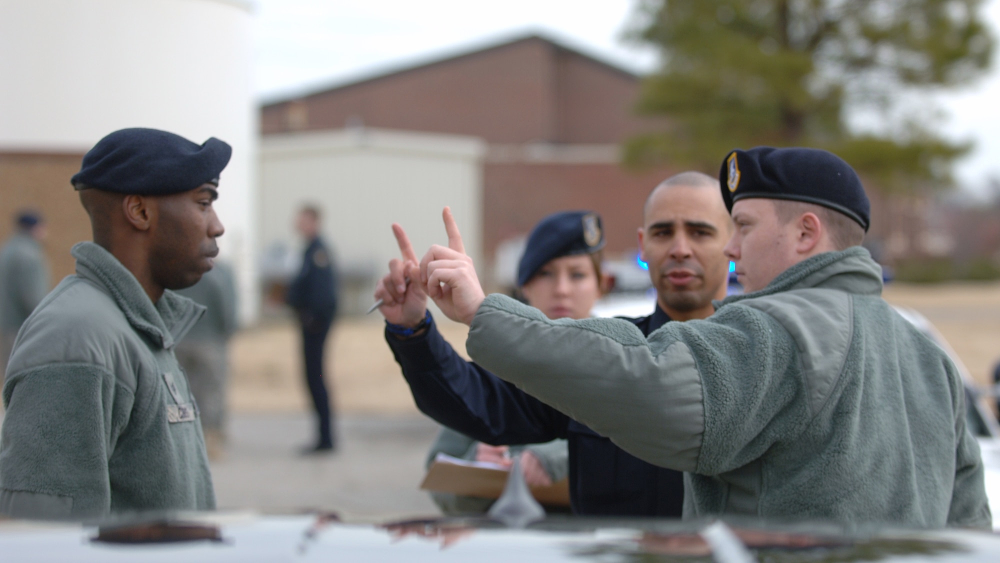 LANGLEY AIR FORCE BASE, Va. -- James City County Master Police Officer Marc Marchand (in black) advises Senior Airman Brandon Kohler, 633d Security Forces Squadron patrolman, how to properly administer a field sobriety test to Staff Sgt. Chris Cobbs, 633 SFS desk sergeant, during a training exercise Jan. 20 at Herron Hall. The JCC Police Department provided expert officers to train security forces personnel how to perform the test and apprehend impaired drivers, which are requirements for all law enforcement officers operating in Virginia. (U.S. Air Force photo/Airman 1st Class Jason J. Brown) (RELEASED)