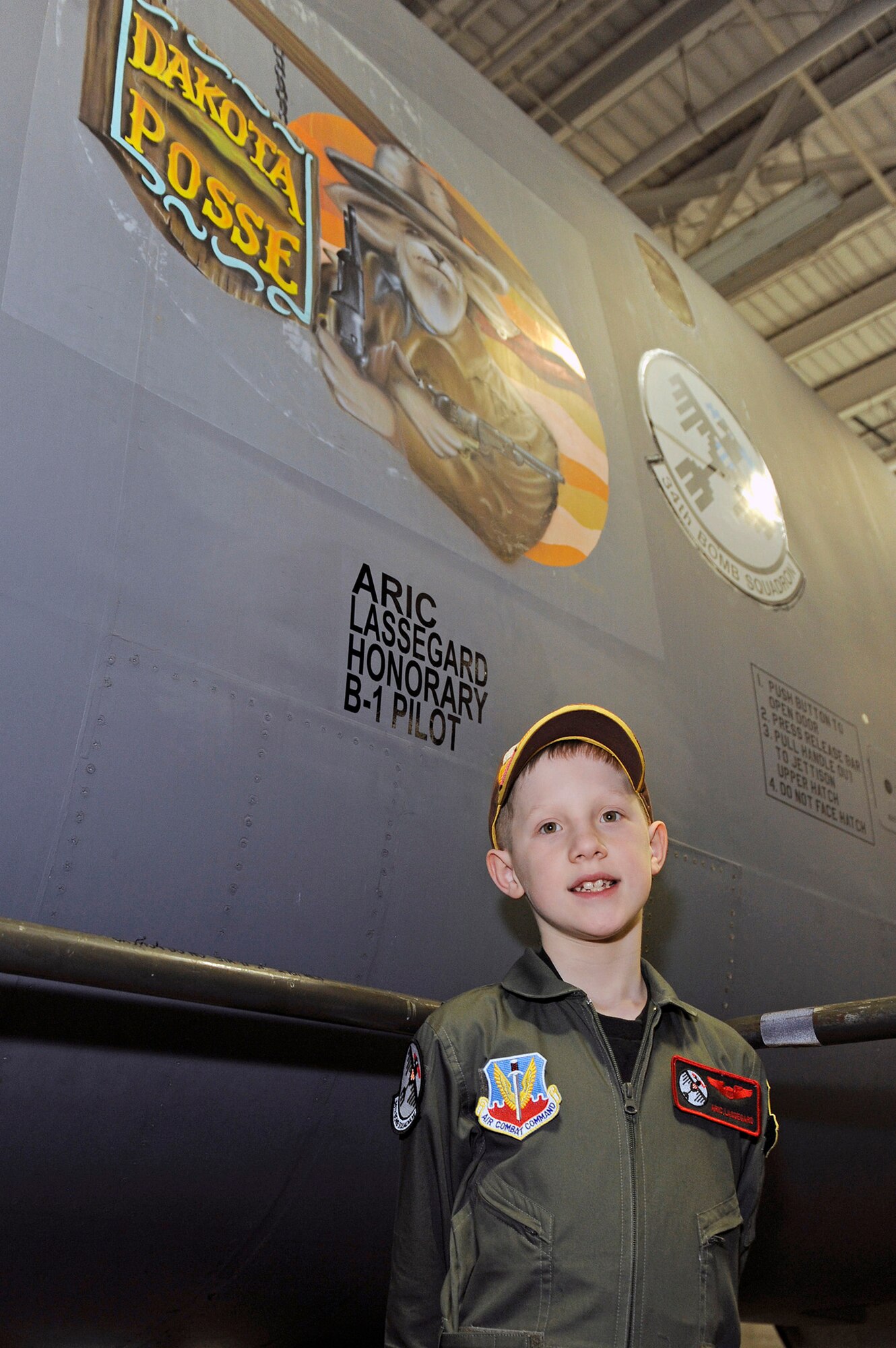 Aric Lassegard stands in front of a B-1B Lancer with his name painted on the nose Jan. 13, 2011, at Ellsworth Air Force Base, S.D. Aric was treated as an honorary member of the 34th Bomb Squadron as part of the Aircrew for a Day program. (U.S. Air Force photo/Staff Sgt. Marc I. Lane)