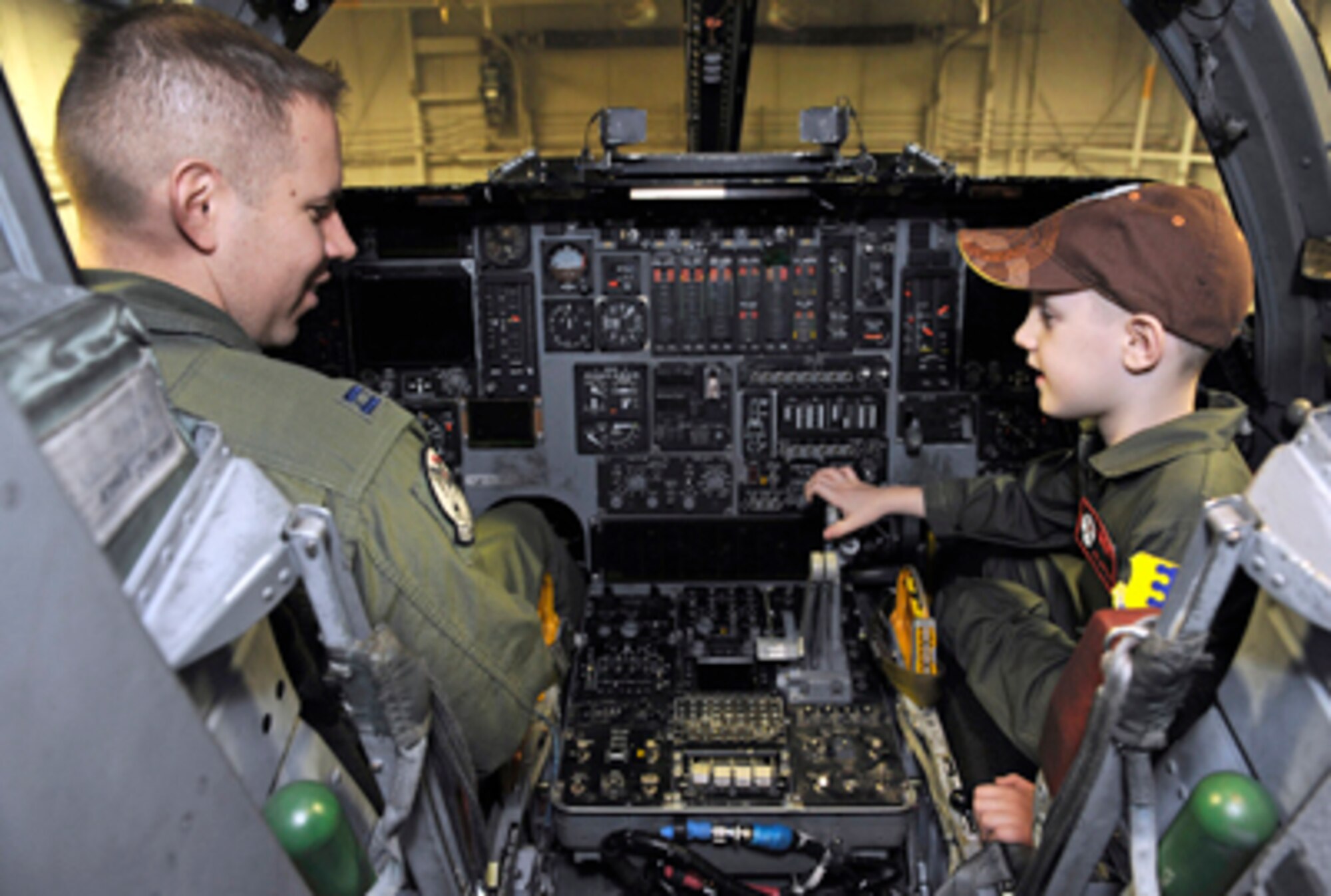 Capt. Chris Williams shows Aric Lassegard the flight controls aboard a B-1B Lancer Jan. 13, 2011, at Ellsworth Air Force Base, S.D. Aric was treated as an honorary member of the 34th BS as part of the Aircrew for a Day program. Captain Williams is a 34th Bomb Squadron pilot. (U.S. Air Force photo/Staff Sgt. Marc I. Lane)