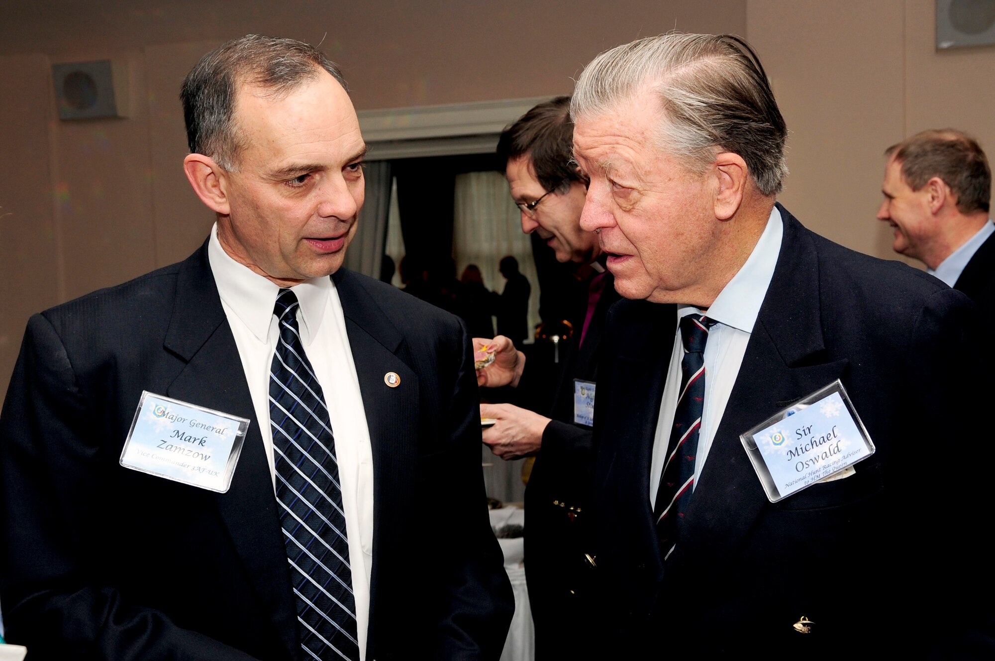 RAF MILDENHALL, England -- Maj. Gen. Mark Zamzow, 3rd Air Force vice commander, talks with Sir Michael Oswald, National Hunt Racing advisor to Her Majesty the Queen, during the 3rd Air Force Winter Reception here Jan. 15, 2011. The reception was held to give General Zamzow, and base leadership from RAFs Mildenhall and Lakenheath, the chance to meet with Members of Parliament, local Mayors and honorary commanders.