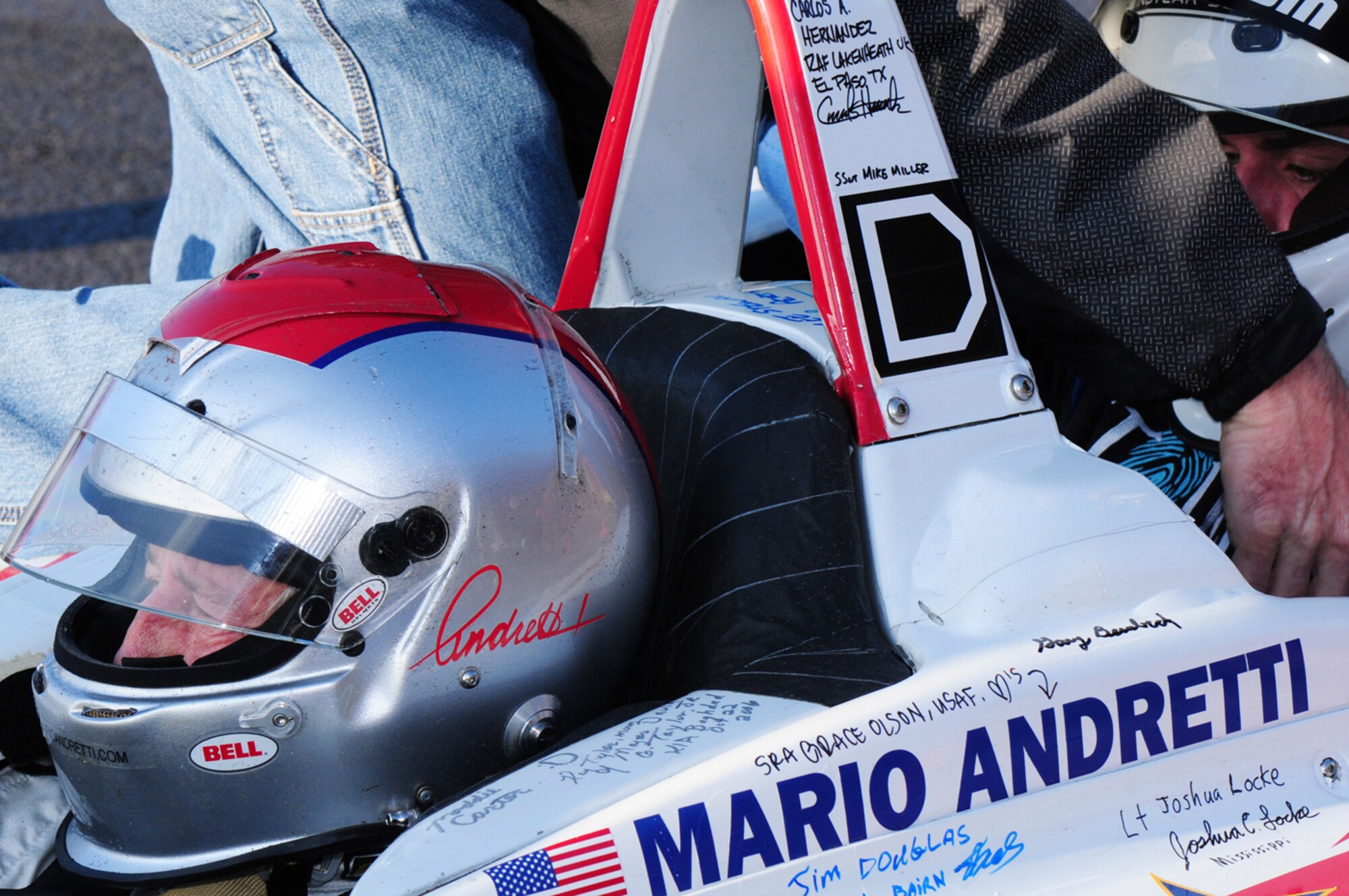 RAF MILDENHALL, England – Troops visited by racing drivers got the chance to sign Mario Andretti’s two-seater IndyCar when it was taken around the world on the Indy 500 Centennial Tour. Folks from RAF Mildenhall also ensured it was marked with the base’s "Box D" stickers Jan. 11, 2011, as a momento.
(U.S. Air Force photo/Karen Abeyasekere)
