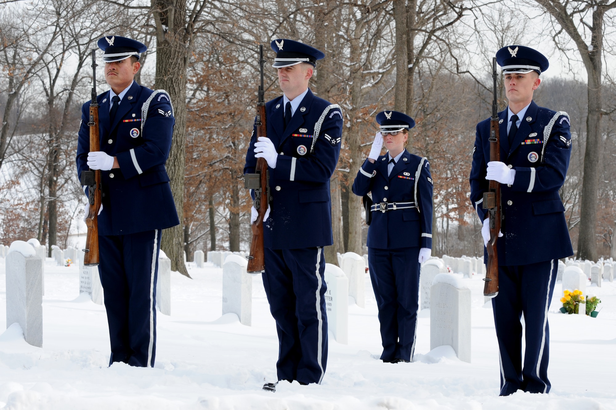 Members of the 375th Air Mobility Wing Honor Guard firing party salute during a funeral procession, Jan. 21, 2010 at the Jefferson Barracks National Cemetery, Mo. The Scott Honor Guard performs numerous details for veterans at this cemetery as well as covering funerals throughout a four state region. Airmen of all ranks and units are assigned to the Honor Guard for four months at a time. (U.S. Air Force photo/Staff Sgt. Brian J. Valencia)