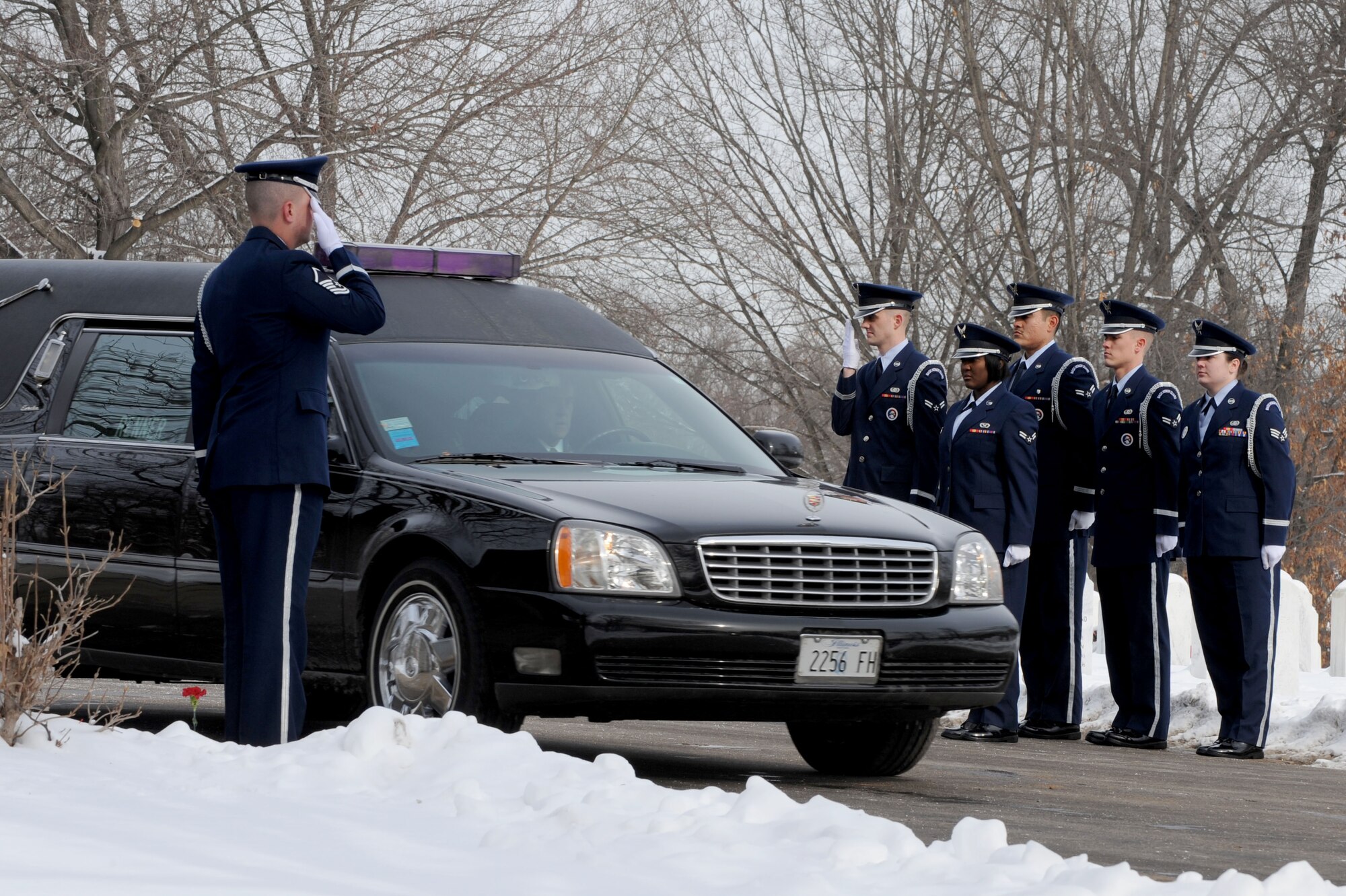 Members of the 375th Air Mobility Wing Honor Guard salute a hearse carrying the remains of a deceased veteran during a funeral procession, Jan. 21, 2010 at the Jefferson Barracks National Cemetery, Mo. The Scott Honor Guard performs numerous details for veterans at this cemetery as well as covering funerals throughout a four state region. Airmen of all ranks and units are assigned to the Honor Guard for four months at a time. (U.S. Air Force photo/Staff Sgt. Brian J. Valencia)